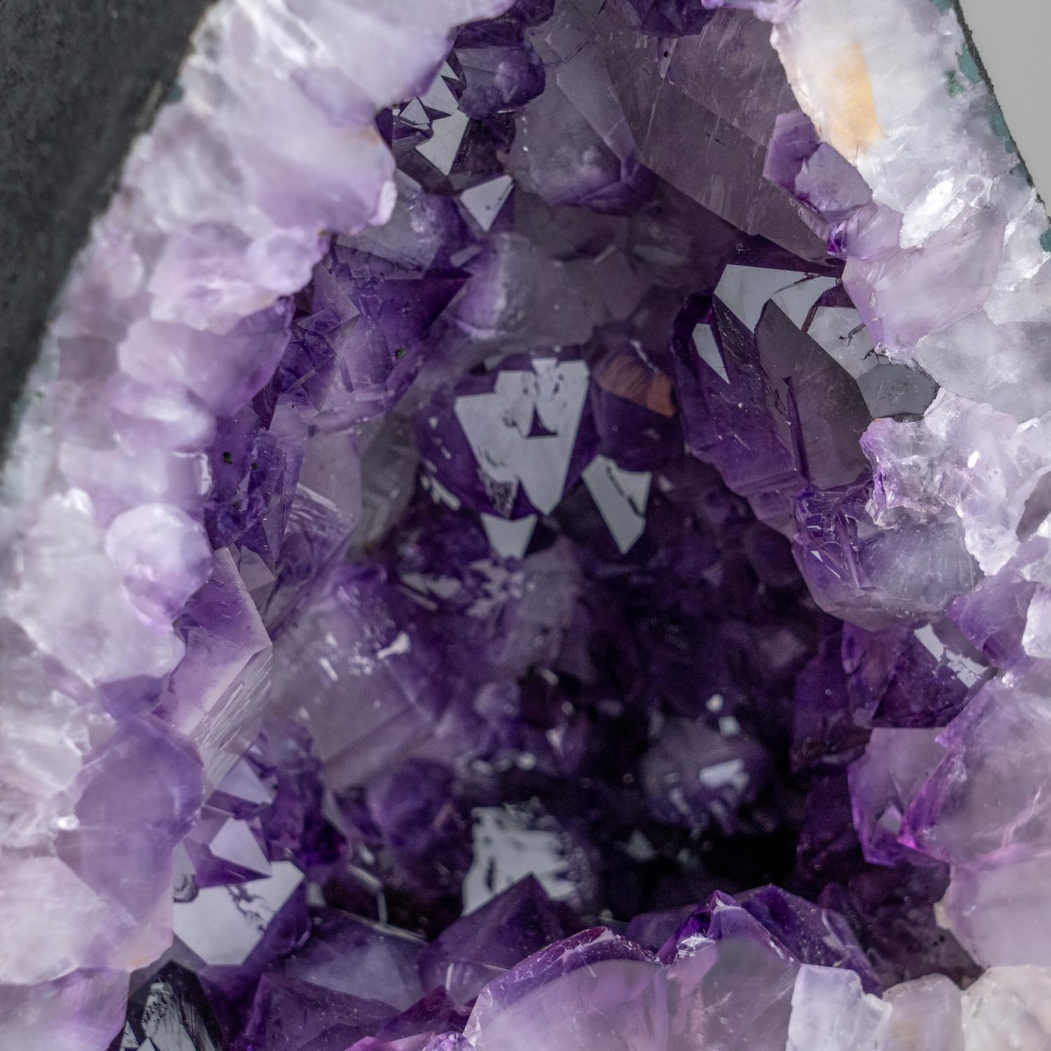 This Genuine Amethyst Cluster Geode from Uruguay is a top quality natural formation of gem amethyst. The half geode cathedral decor features lustrous fully terminated crystals with highly reflective faces and a deep, transparent to translucent grape