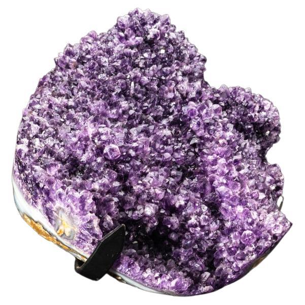 AAA Quality Brazilian deep-grape Amethyst crystal cluster - handmade and formed into a free-form shape. This beautiful specimen comes with a metal stand and is perfect display piece.

Amethyst is a very powerful and protective crystal, and is a