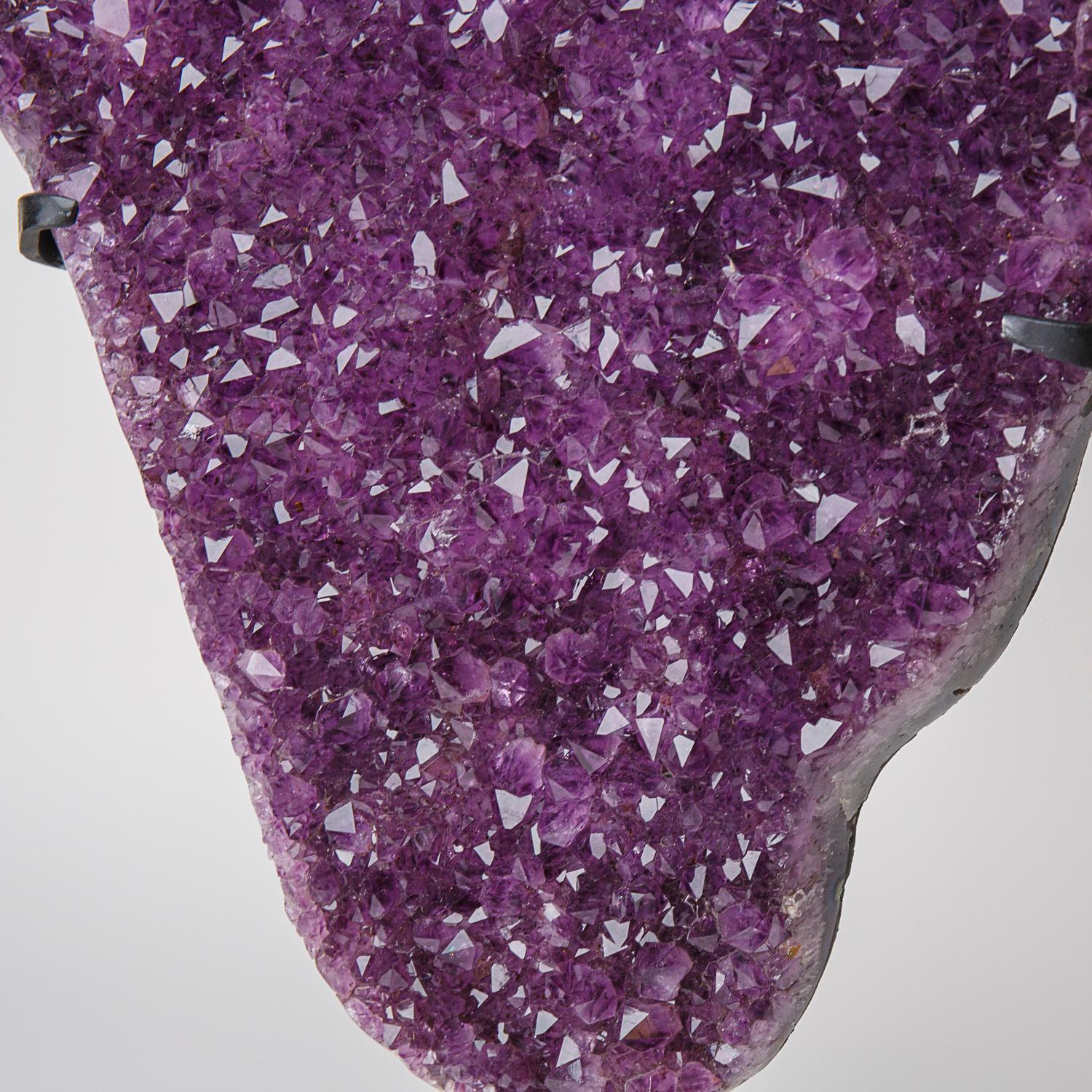 This museum quality Amethyst Quartz Cluster features naturally formed, lustrous and fully terminated crystals with highly reflective faces and a deep, transparent to translucent hues. This beautiful specimen comes with a metal stand and is perfect