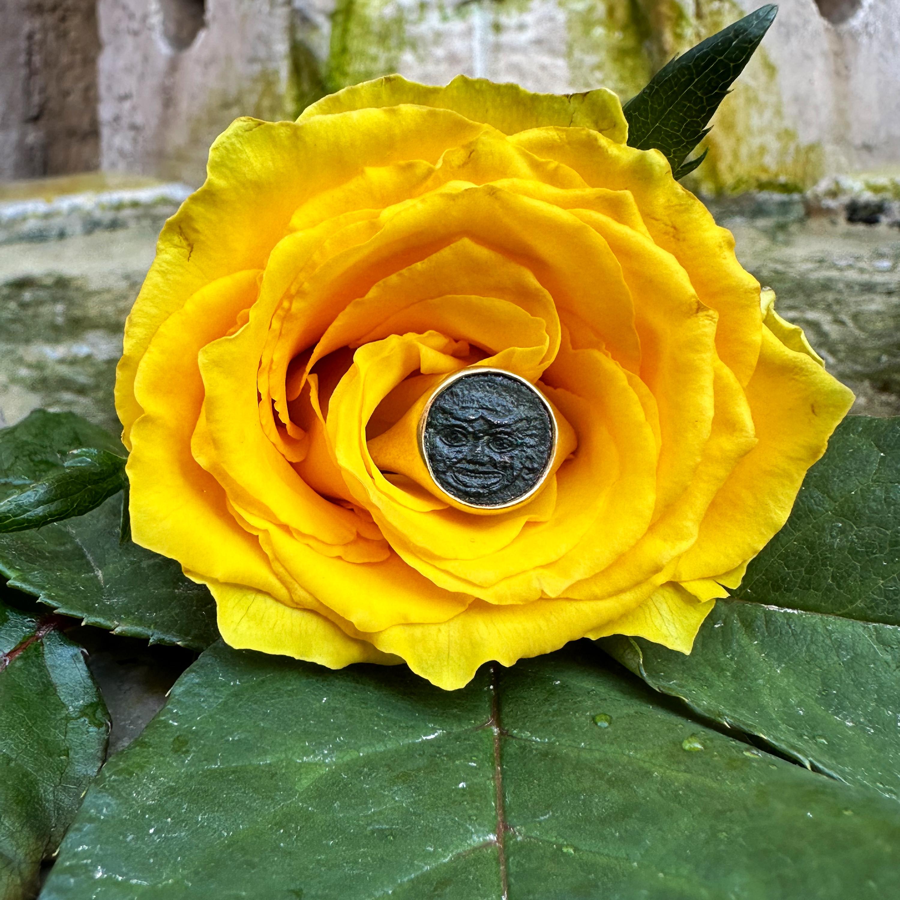 This exquisite 18 kt gold ring features an authentic bronze Greek coin from 420-405 BC, adorned with a striking depiction of the Gorgon, a mythical figure steeped in ancient lore.

 In Greek mythology, Gorgons, including the infamous Medusa, were