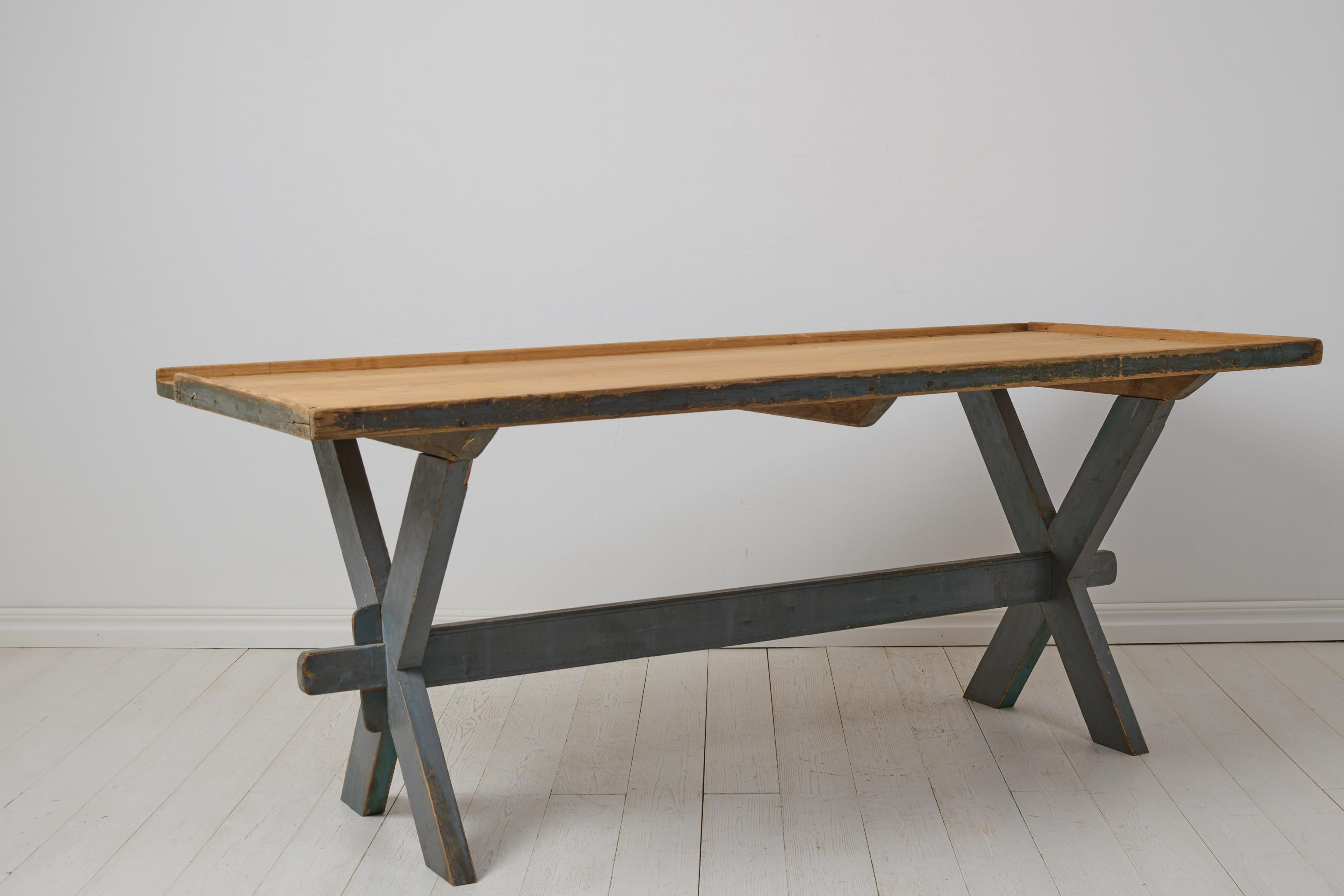 Antique dining or work table from northern Sweden. The table is a genuine Swedish country house furniture from the 1840s to 1850s. The table is a trestle table with a solid table top on a leg frame. Good height and measurements for a dining table