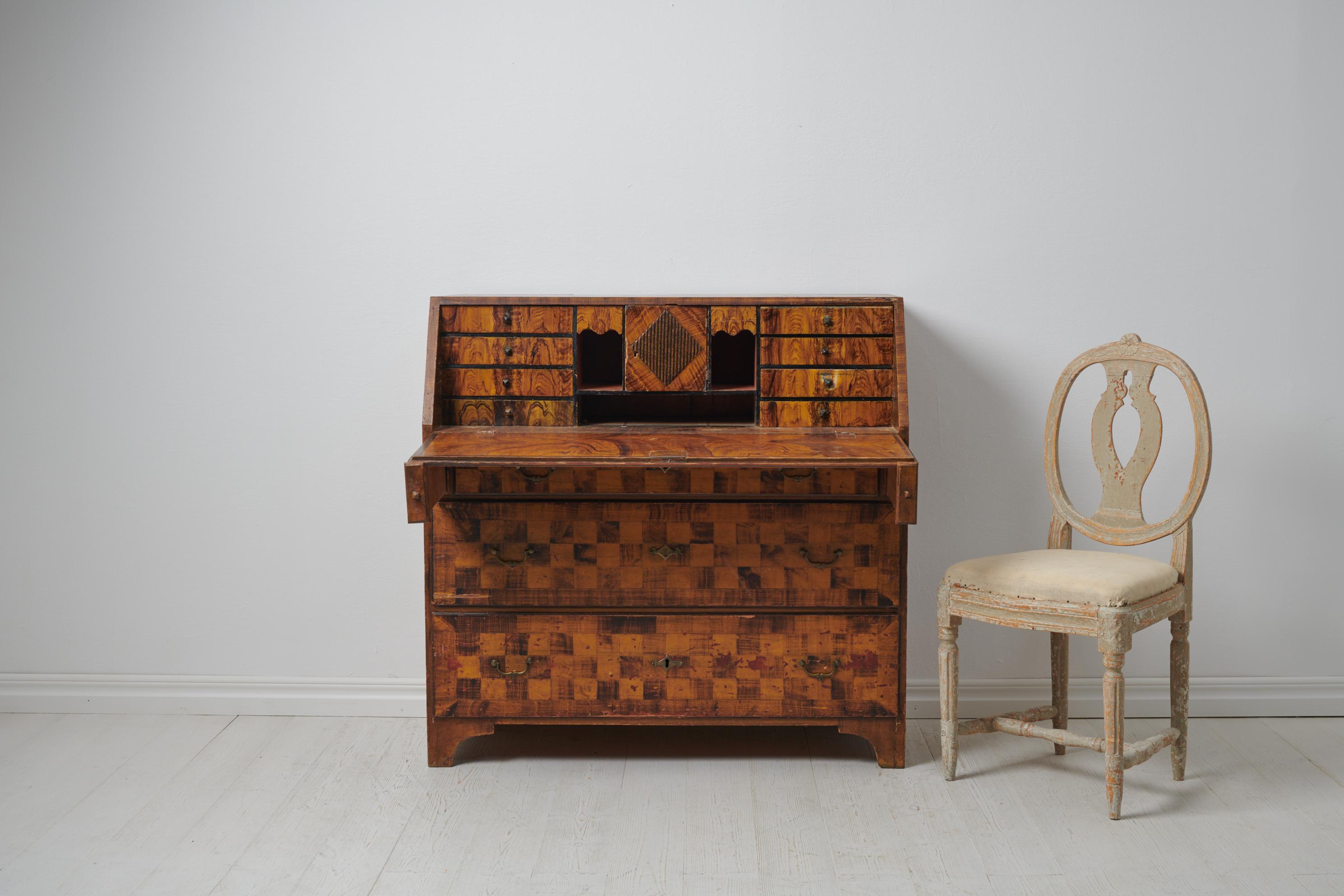 Genuine antique writing bureau from northern Sweden. The bureau is Swedish and made in painted pine during the early 1800s, around 1810. It has a very unusual paint which is the artist’s free interpretation of walnut wood. The bureau was painted