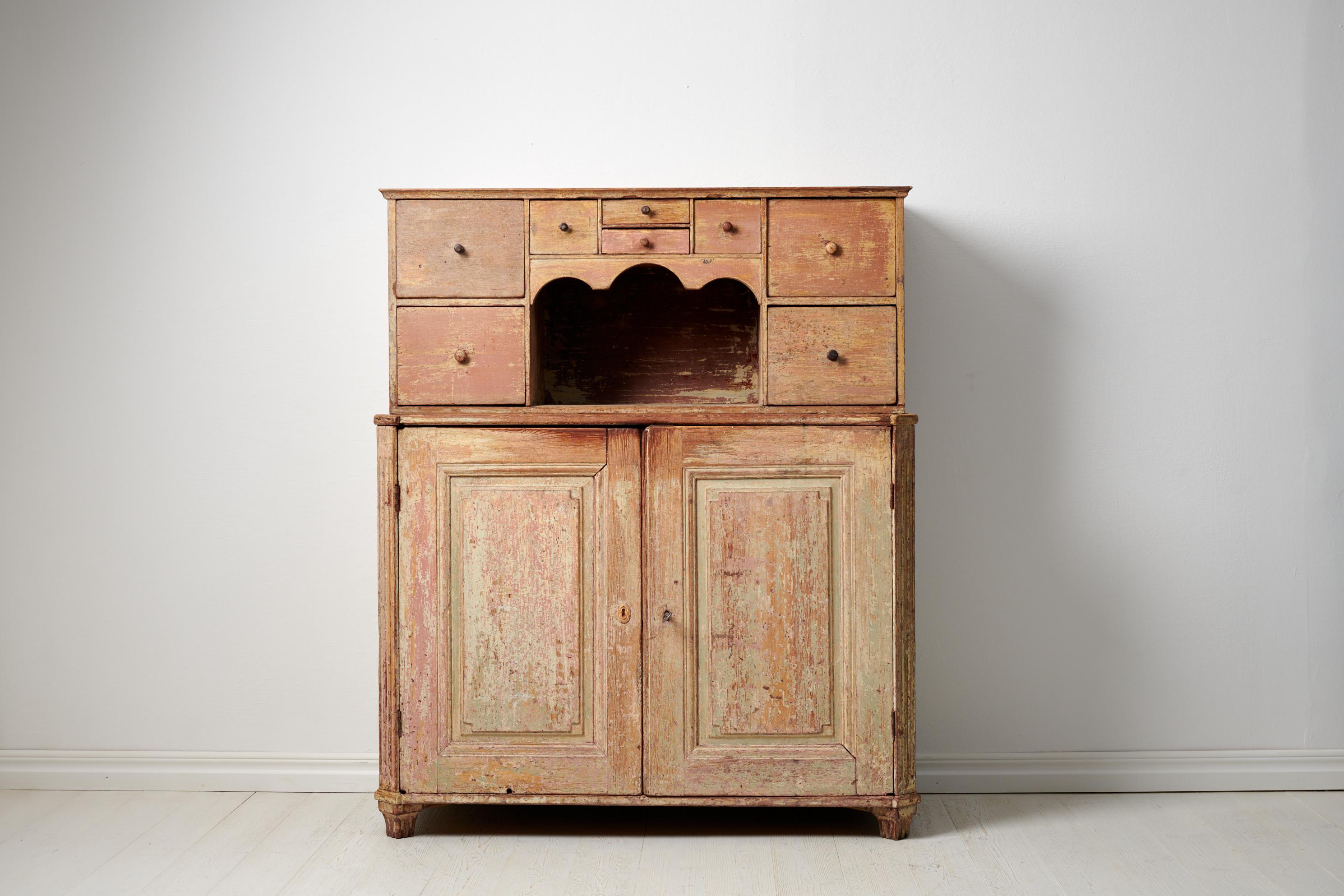 Genuine Swedish gustavian sideboard from northern Sweden. Th sideboard is a genuine country house furniture made around 1790. The frame is solid pine and the interior has two drawers as well as shelves. More unusual is the top section with drawers