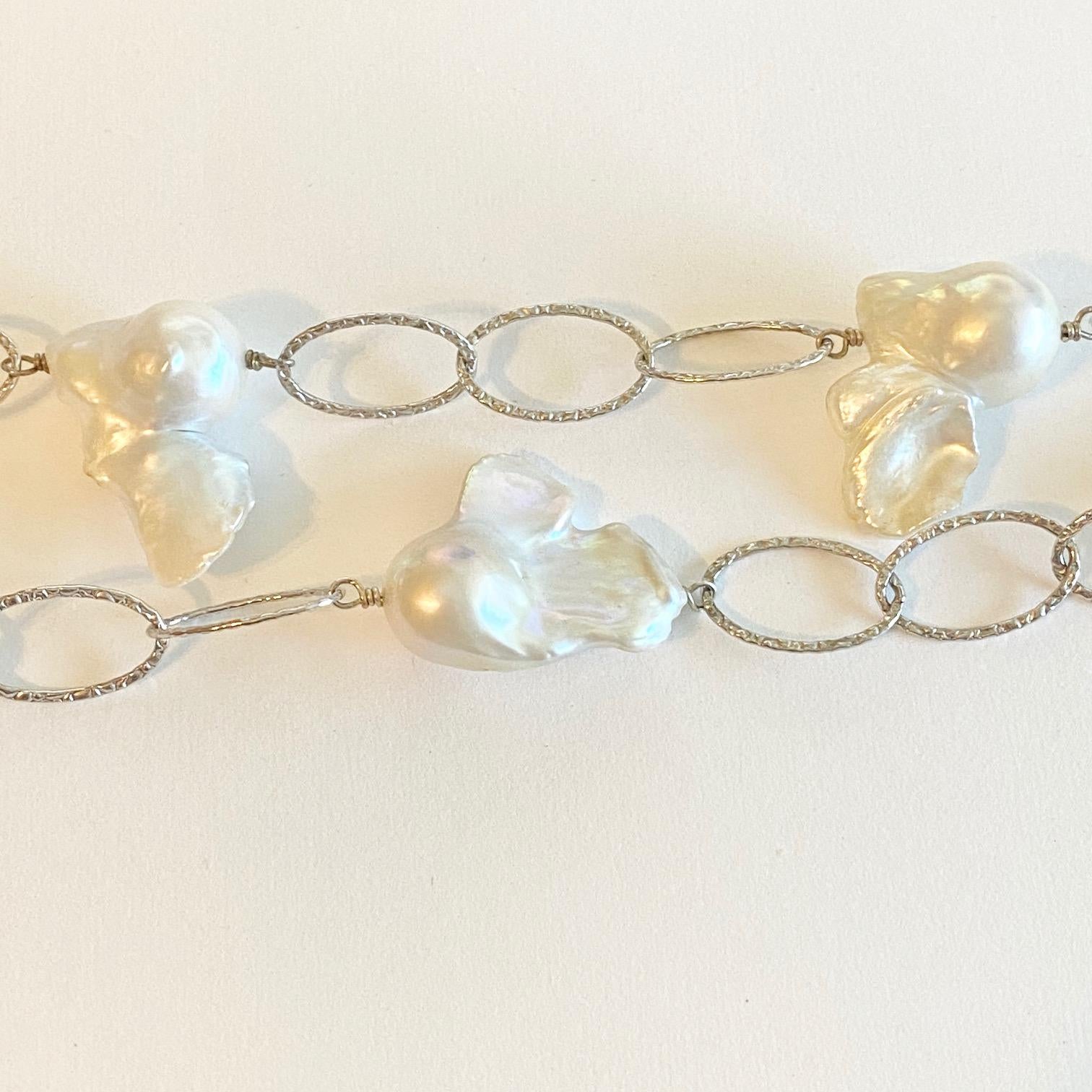 This sterling silver and pearl necklace has a charismatic personality to it that catches everyone's attention! It is made with real genuine  baroque pearls and is 36 inches long. The cultured freshwater pearls have unique and organic shapes to them,