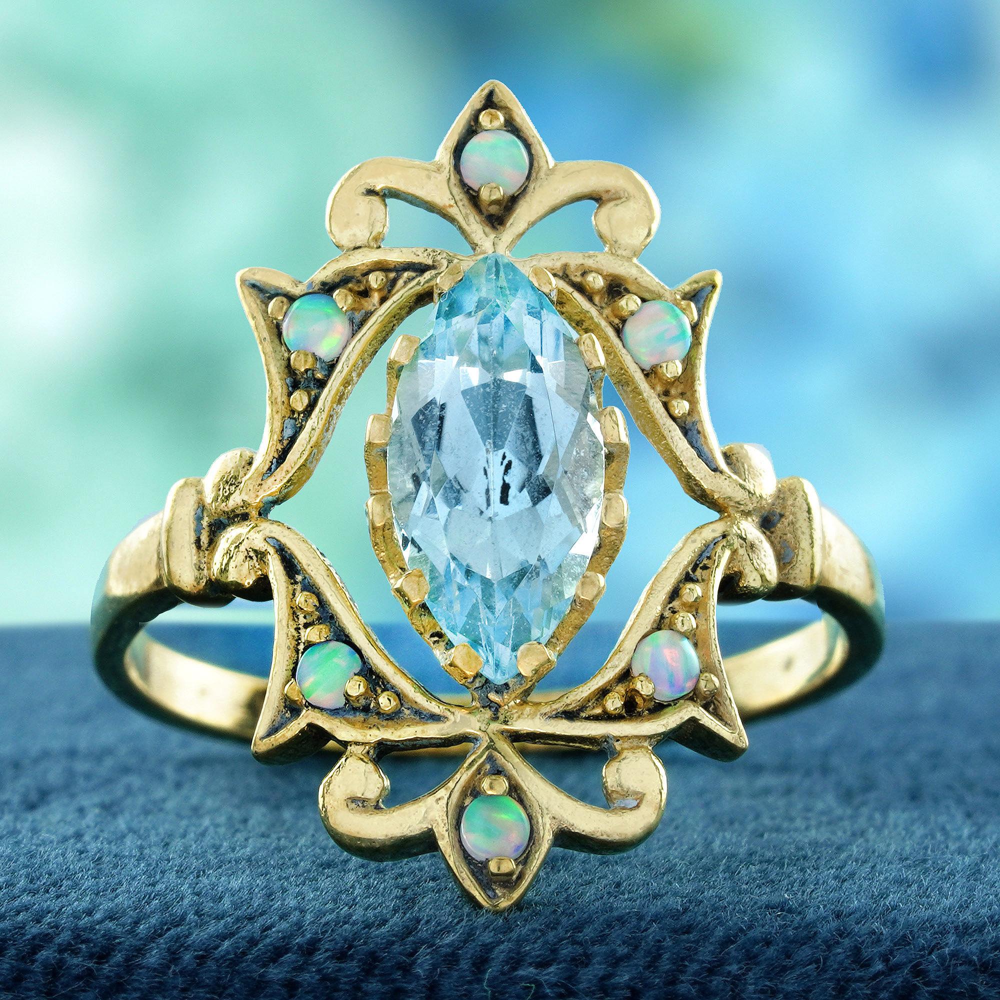 This ring presents an elegant and distinctive vintage-inspired design. The centerpiece is a marquise-cut sky blue topaz. This central stone is surrounded by small opals accents, creating a charming floral or starburst pattern around the topaz,