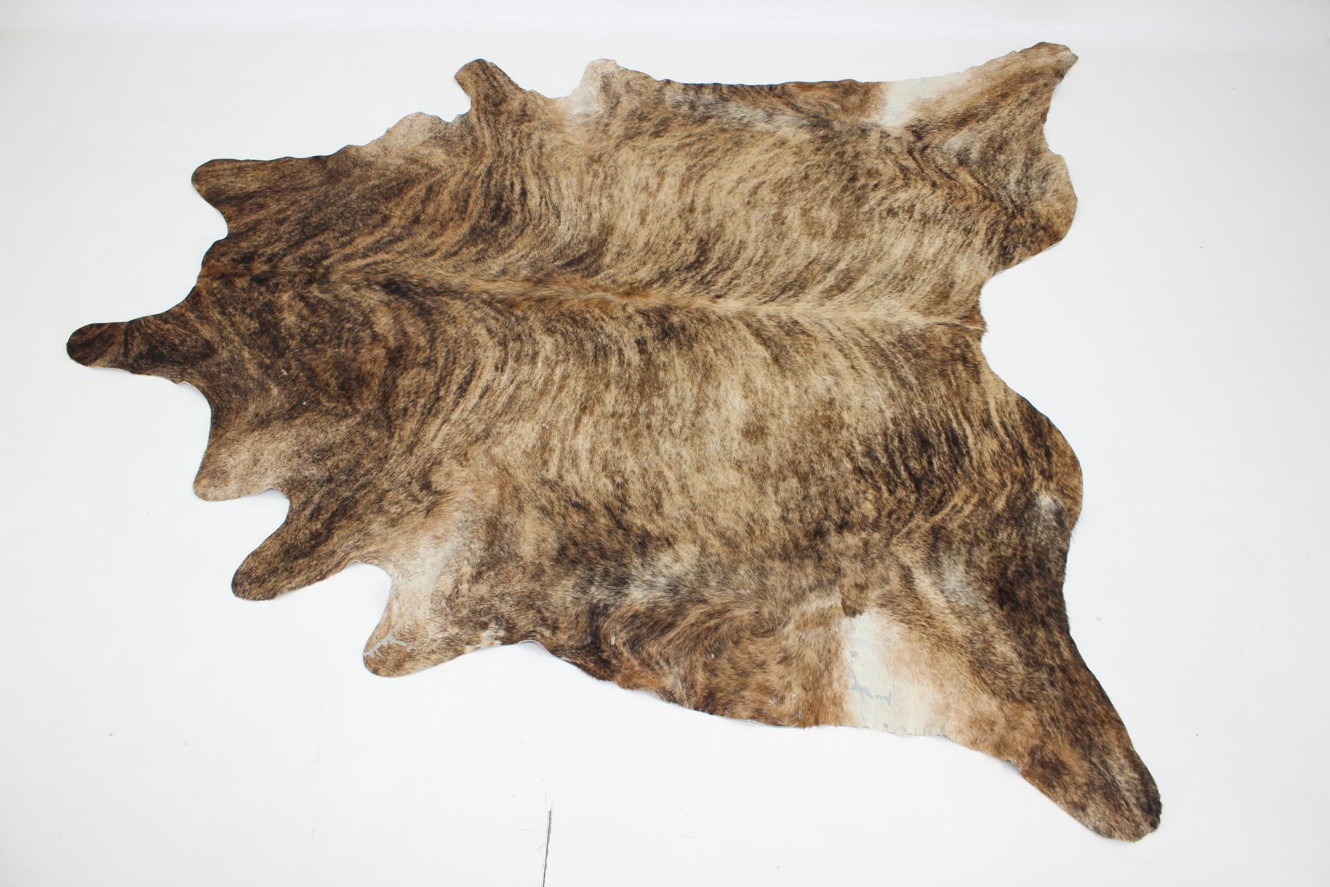 Genuine Brazilian cowhide leather of beautiful brindle colour in very good condition. 
A great way to add personality to your interior.