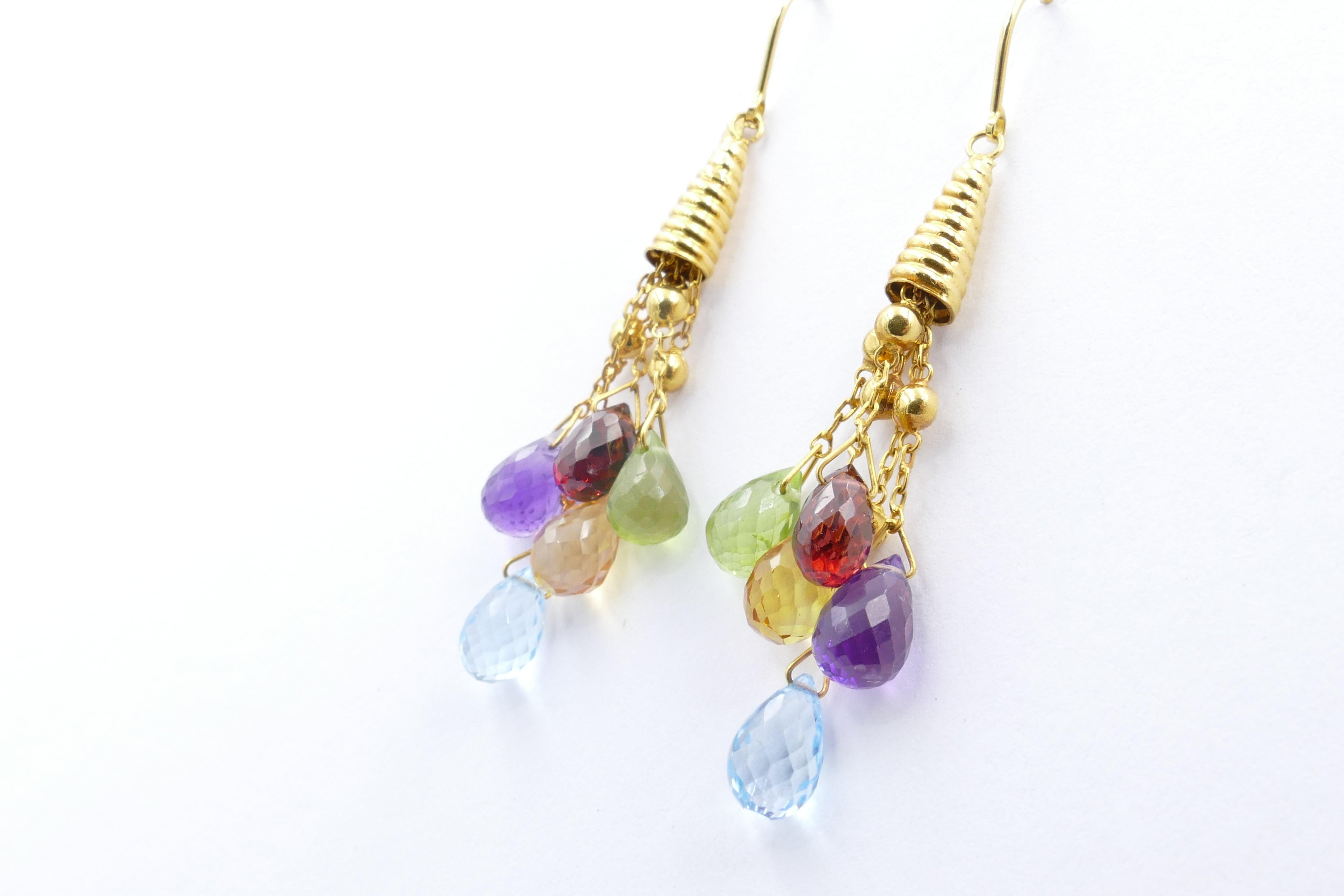 Set in 18ct Yellow Gold these swinging Chandelier Earrings are composed of multi genuine Burmese
 (thought to be the best in the world) Gemstones.
Included are Citrine, Aquamarine, Peridot, Garnet & Amethyst so they would certainly go with every