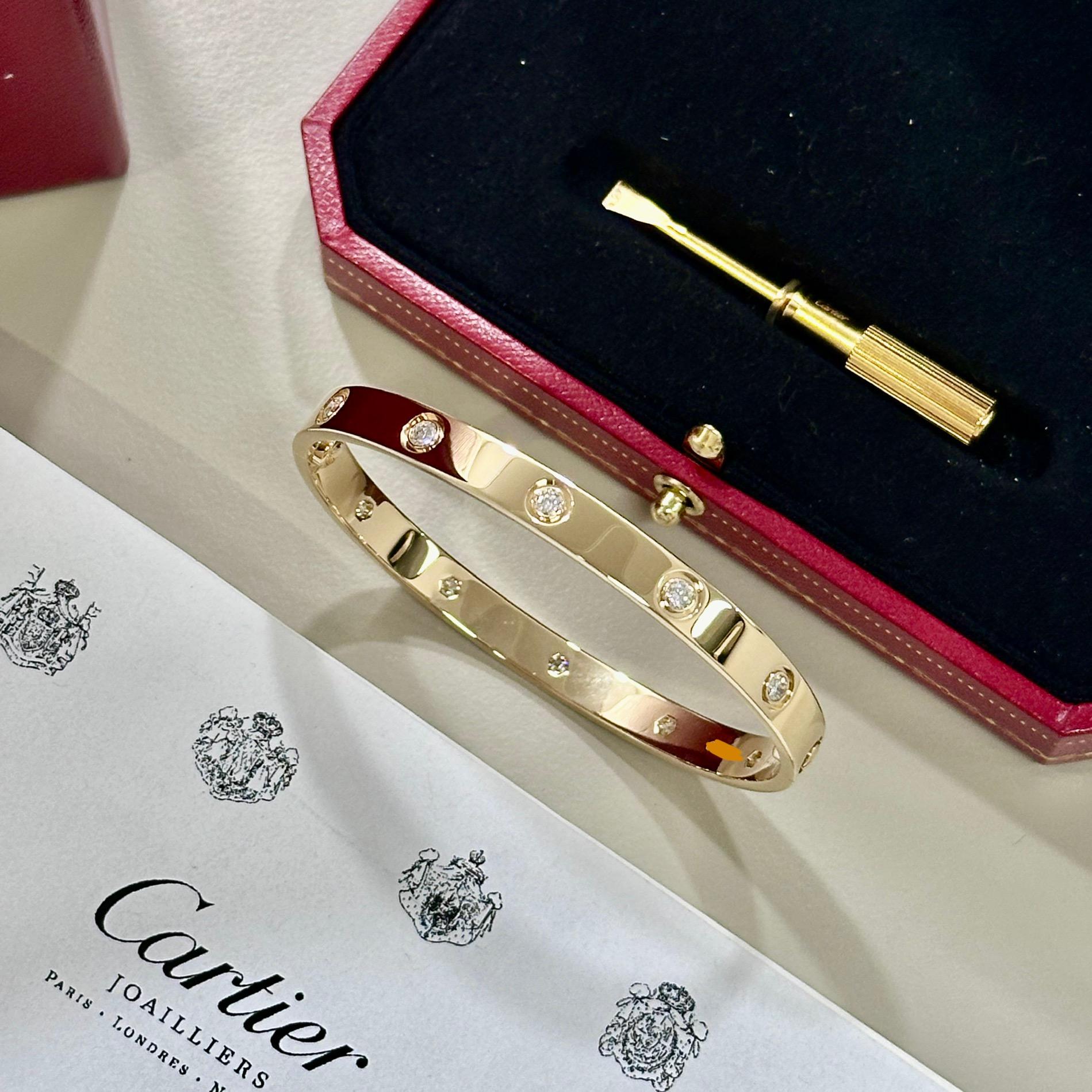 An 18k yellow gold full diamond Cartier bracelet from the Love collection. The bracelet is set with 10 round brilliant cut diamonds circulating the outer edge throughout in a bezel - rub over setting totalling 0.96ct. The bracelet is size 18.

Comes