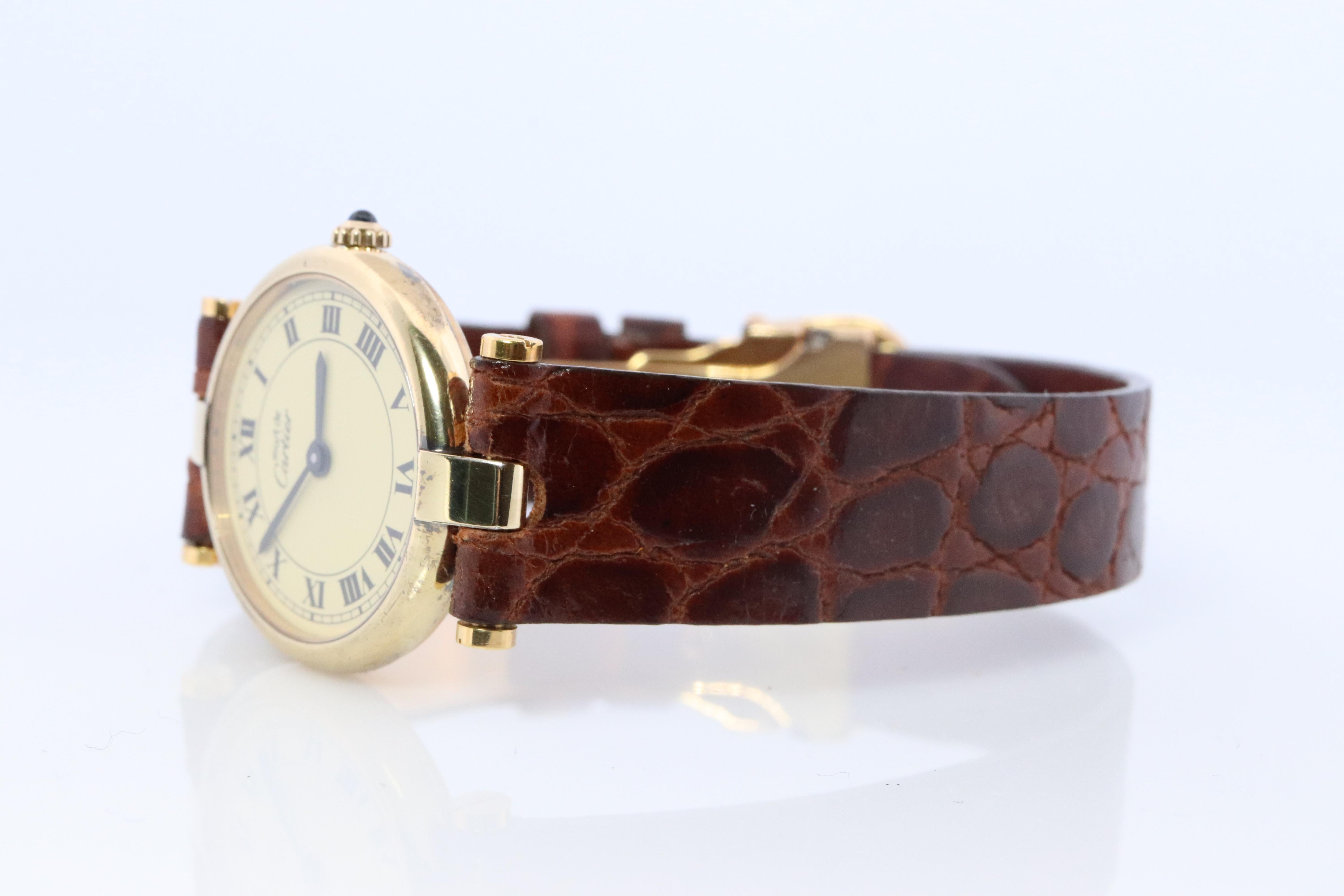 Genuine Cartier watch.

Vintage Must de Cartier Vendome

Rare Champagne dial.

Sapphire Cabochon Crown.

Original Cartier Deployment Buckle.

Condition: Wear consistent with age. New leather band.
New battery installed.

Details:
24mm Round case