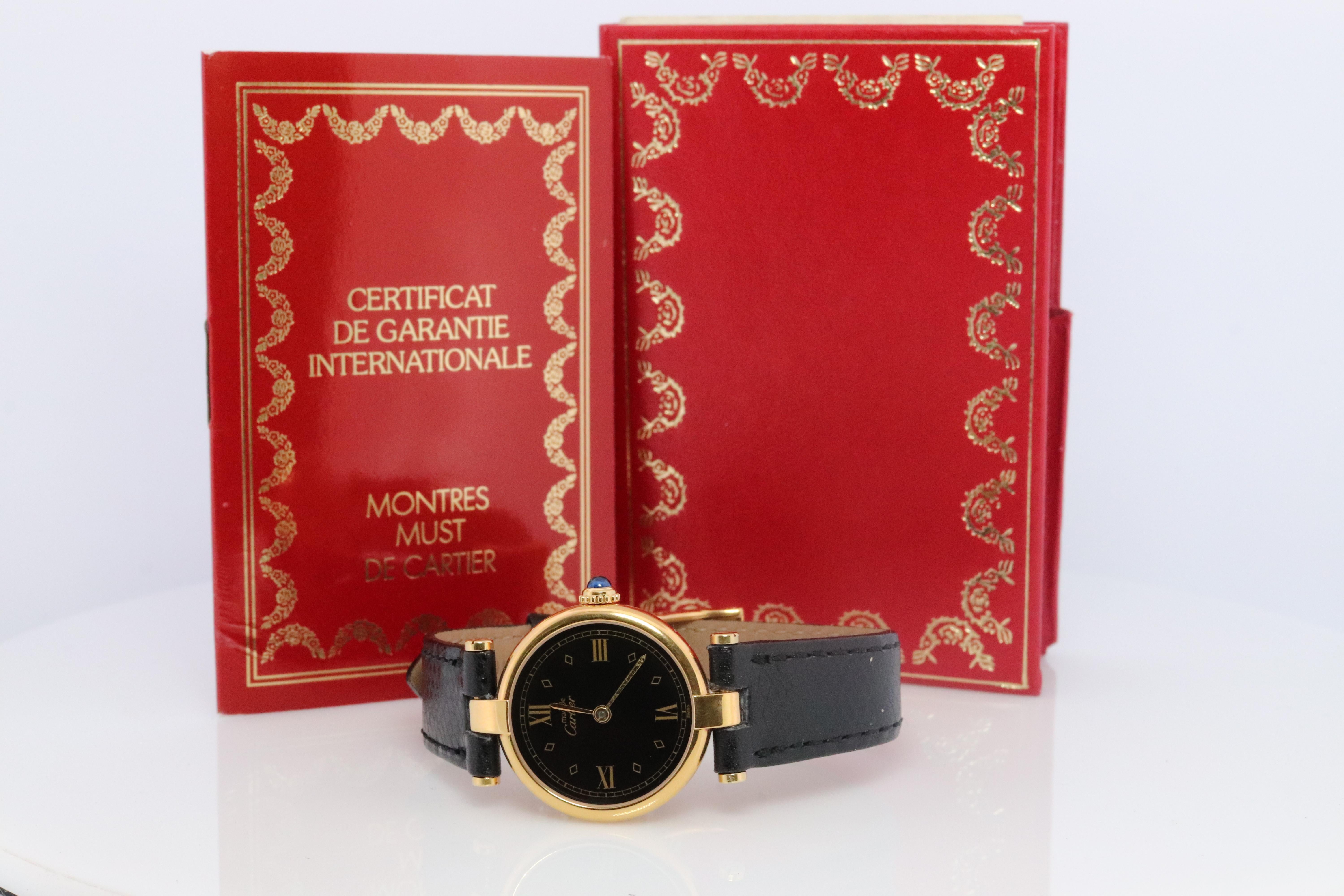 Genuine Cartier watch.

Vintage Must de Cartier Vendome

Rare Black dial.

Sapphire Cabochon Crown.

Original Cartier Paperwork.

New Black Gucci Band.
--Have other colors if you prefer.

Condition: Wear consistent with age. New GUCCI genuine