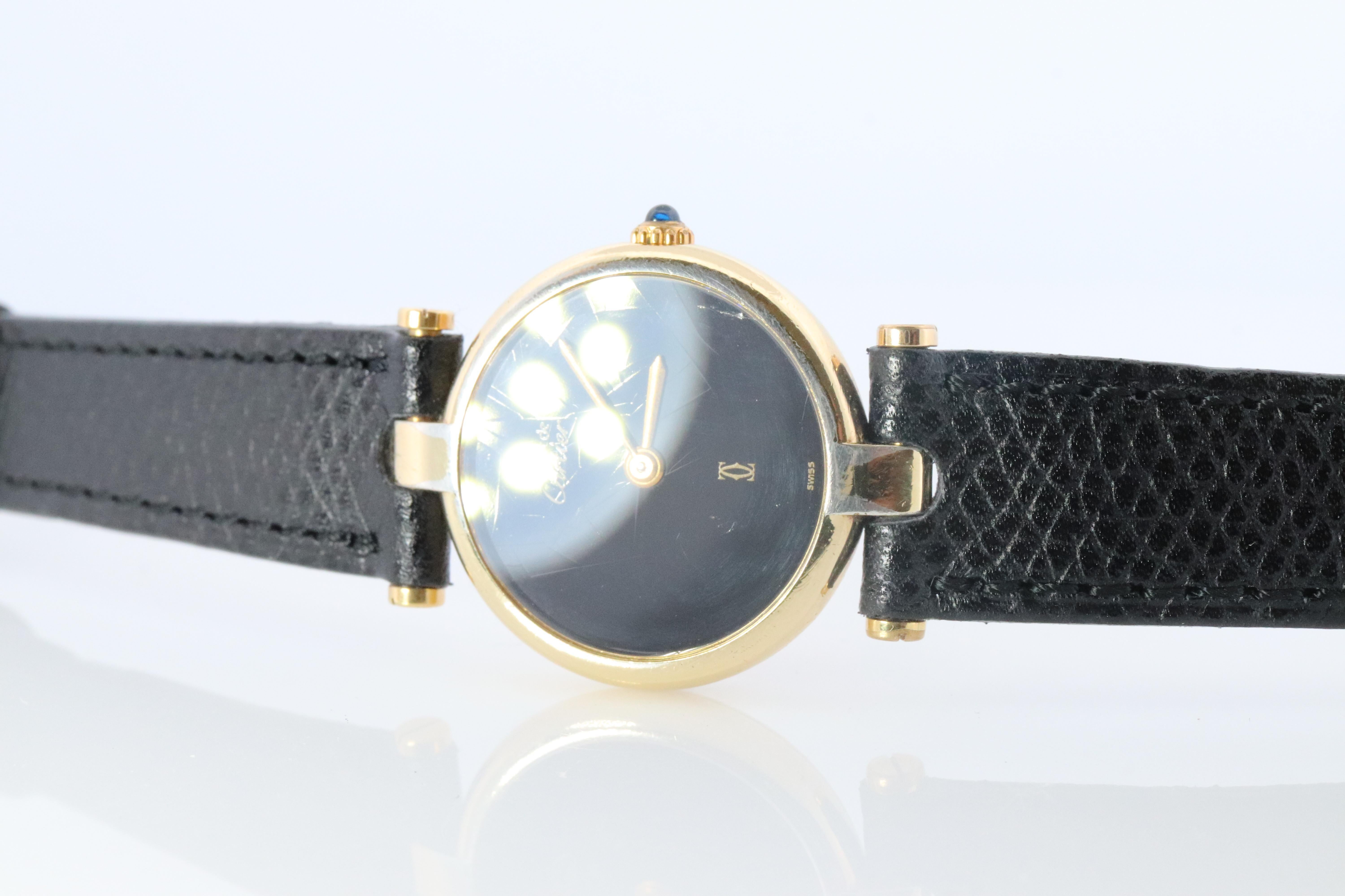 Genuine Cartier watch.

Vintage Must de Cartier Vendome

Rare Black dial.

Sapphire Cabochon Crown.

New Black Gucci Band.
--Have other colors if you prefer.

Condition: Wear consistent with age. 
New battery installed.

Details:
24mm Round case