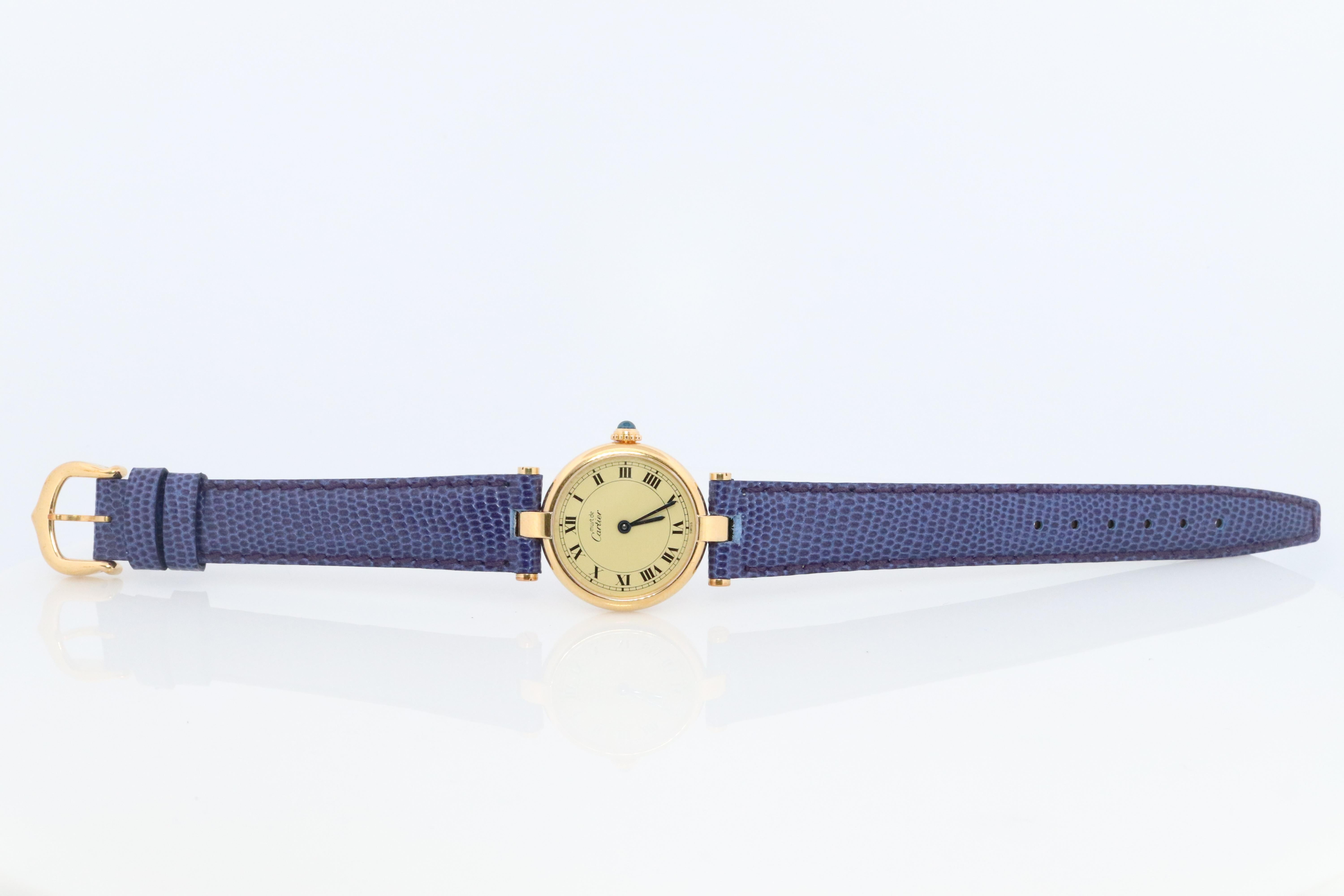 Genuine Cartier watch.

Vintage Must de Cartier Vendome

Rare Cream dial.

Sapphire Cabochon Crown.

Condition: Wear consistent with age. New GUCCI genuine leather blue band.
New battery installed.

Details:
24mm Round case