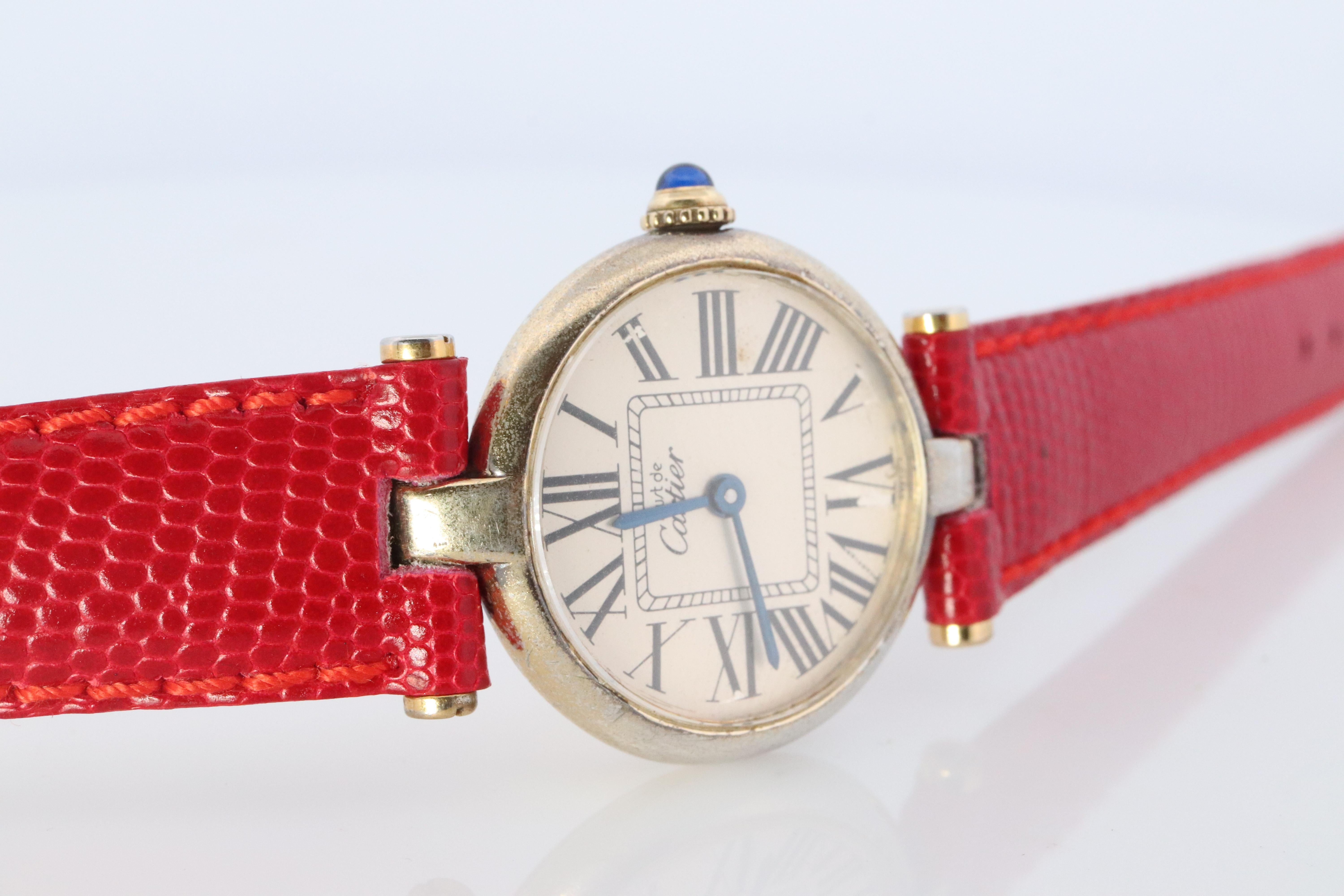 Genuine Cartier watch.
ref. 1851

Vintage Must de Cartier Vendome

Rare Cream dial with square Roman numbers

Sapphire Cabochon Crown.

Condition: Wear consistent with age. Some Plating has worn off. New GUCCI genuine leather red band.
New battery