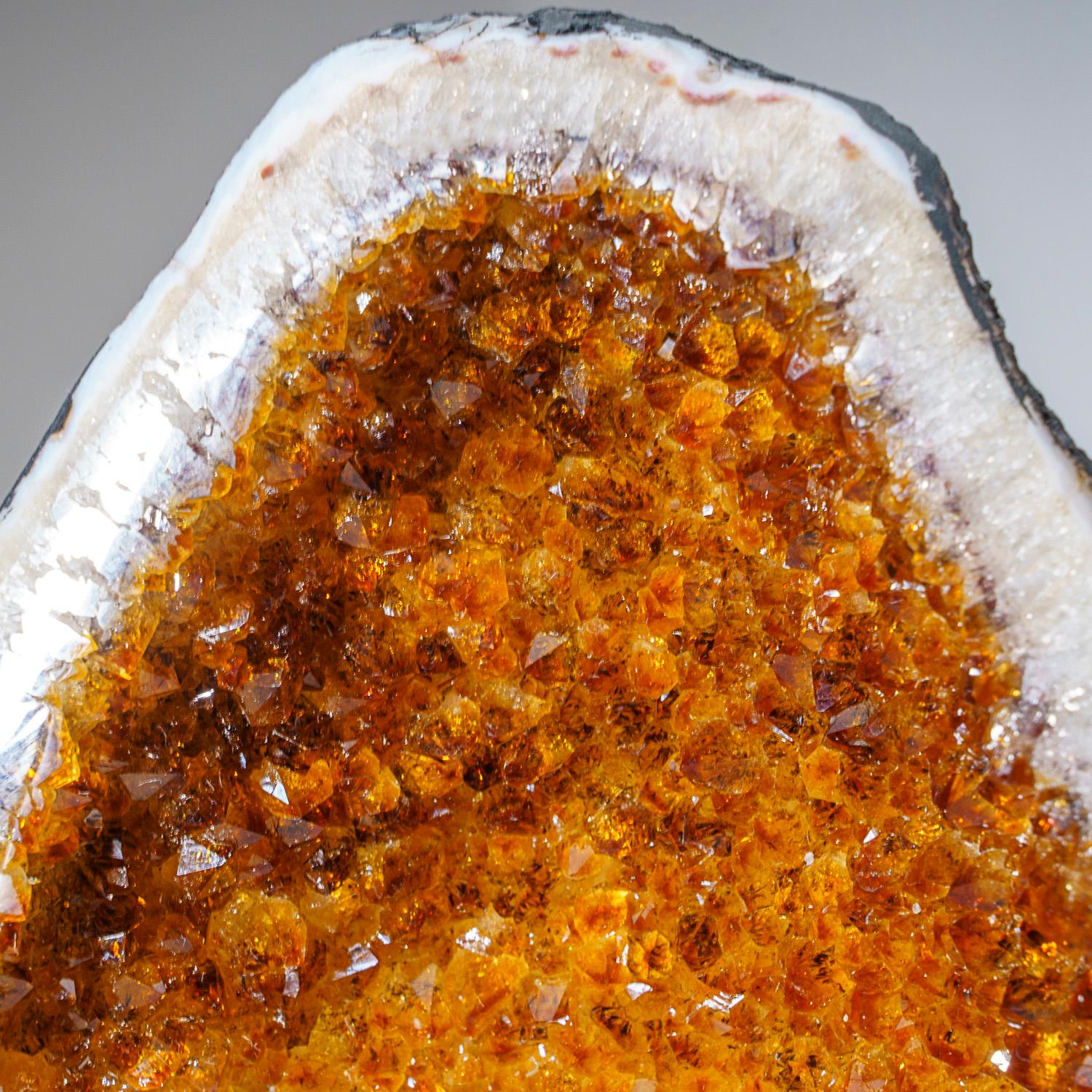 AAA museum quality, large Brazilian citrine geode lined with extra large lustrous, transparent to translucent, golden citrine quartz crystals. This beautiful specimen has vibrant orange/yellow color with highly reflective terminated faces.

Sunny
