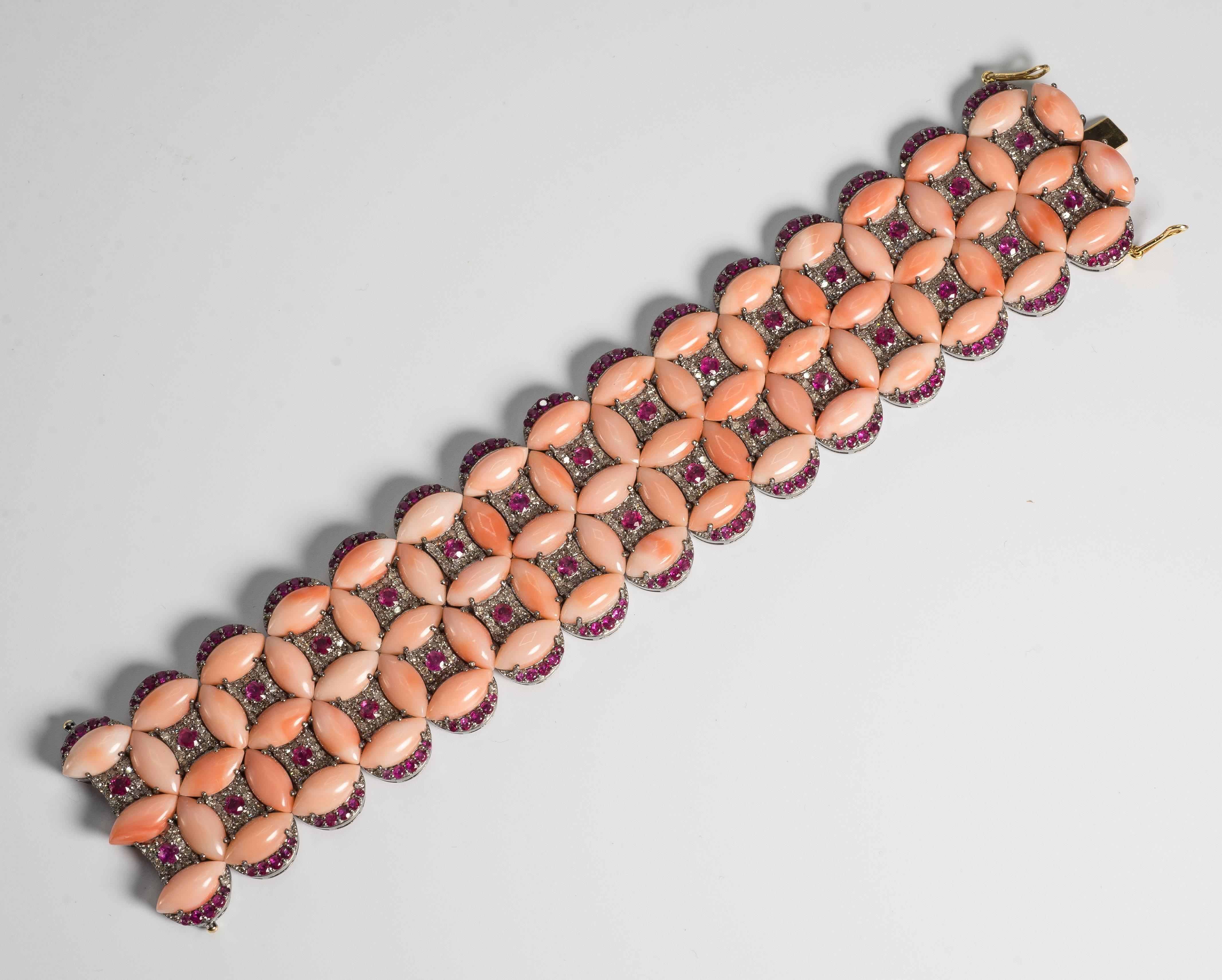 An exquisite Salmon Coral diamond pink tourmaline Tapestry bracelet of stunning substantial design. The marquise cabochon salmon shade corals  are set with diamonds and pink faceted tourmalines well made in silver. The clever designed scalloped