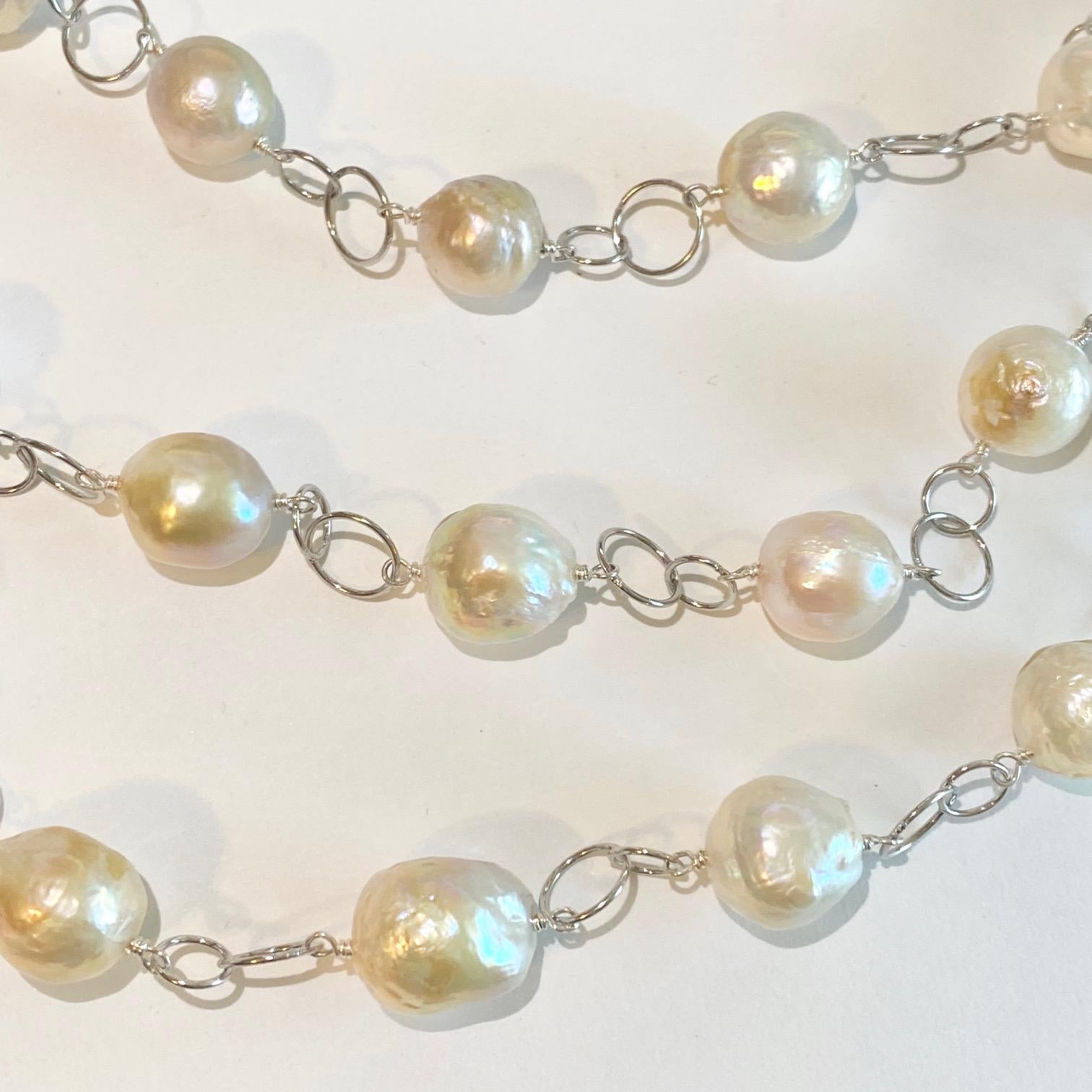 This necklace is one-of-a-kind and made by our jewelry designers in our shop! It is an adjustable, versatile pearl strand necklace with three strands layered with one inch separating each strand! The pearls have gorgeous colors that are pink and