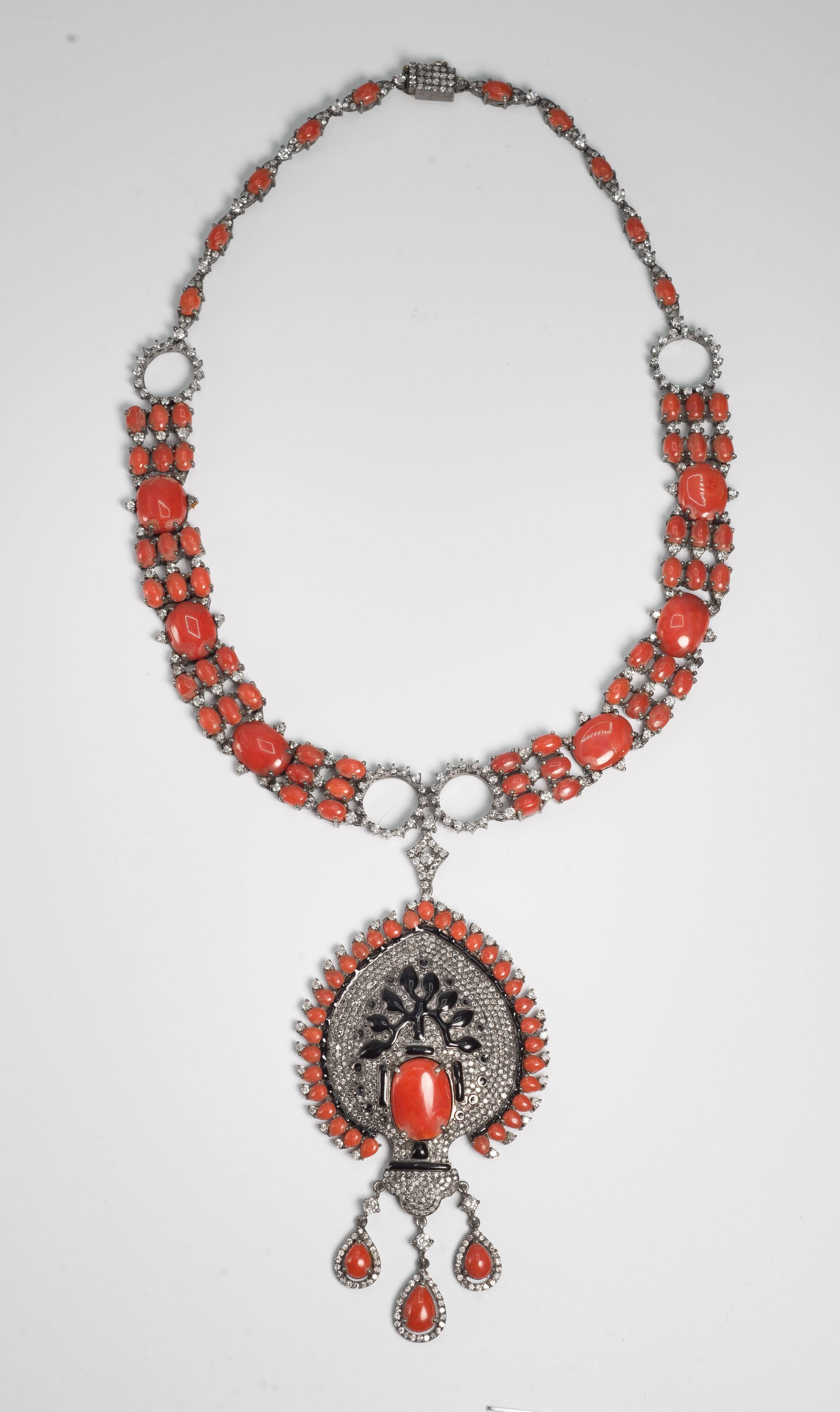 Exquisite modern Art Deco  Tree Of Life design diamond coral cabochon black onyx pendant necklace.
The corals are a beautiful deep orange color, the diamonds are micro pave in antiqued sterling and the necklace is light and flexible with all