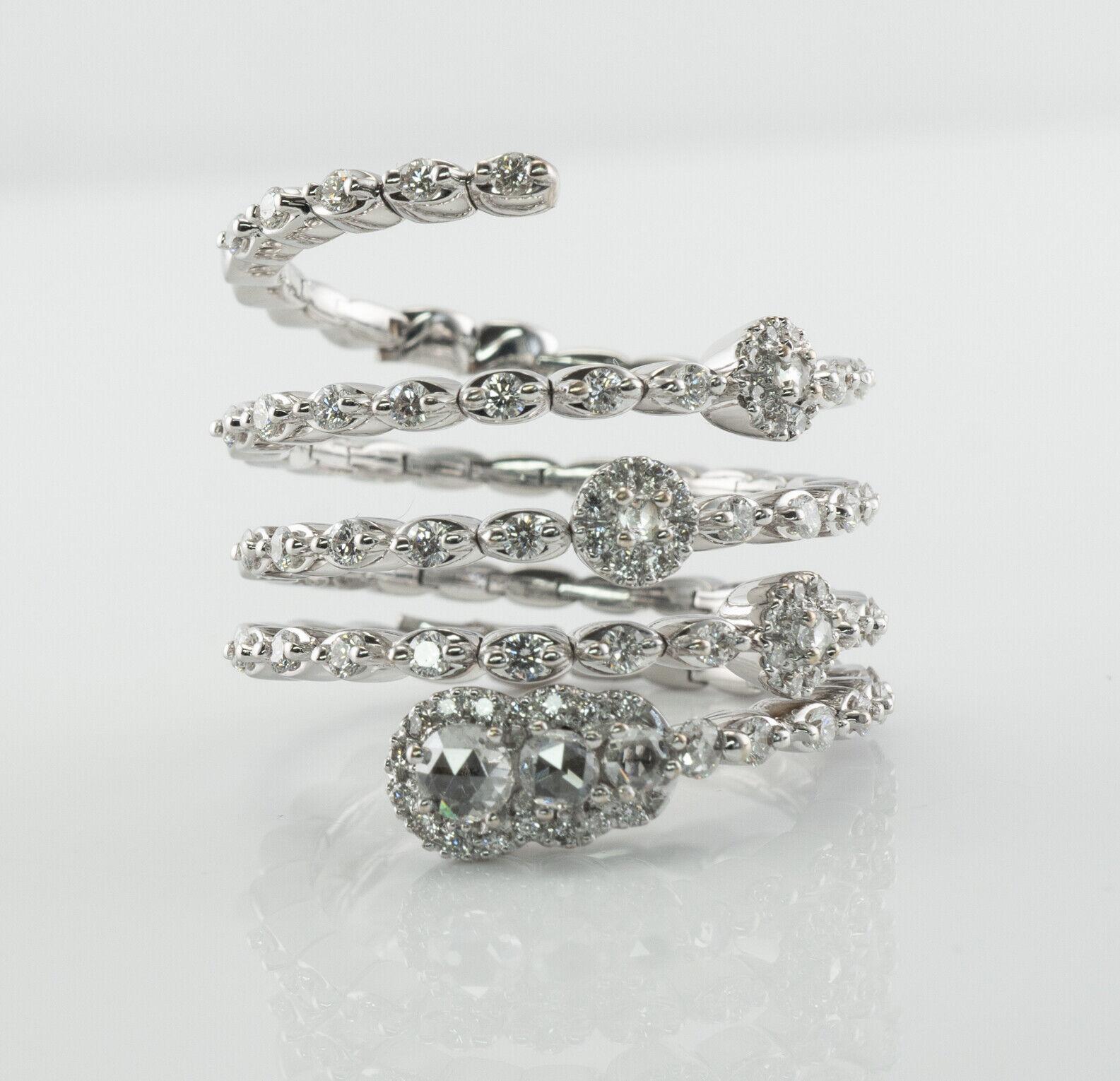 Genuine Diamond Snake Ring 18K White Gold Flexible Band

This circa 1980s very unusual and hard to find ring is made in Milan, Italy and crafted in solid 18K White Gold. 
It is also stamped with Italian registration number 1489 M. 
There are 7