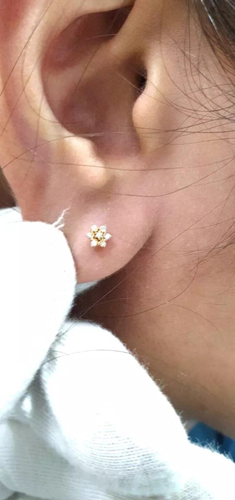 Genuine Diamond star Nose Piercing 14k Gold Ear Nose star Body Piercing

Number of Diamonds
7
Shape
Round
Closure
Screw On
Item Length
6 mm
Metal
Yellow Gold
Diamond Weight
0.10 cts Approx
Main Stone
Diamond
Colour
Gold
Gauge
18 g (1 mm)
Base