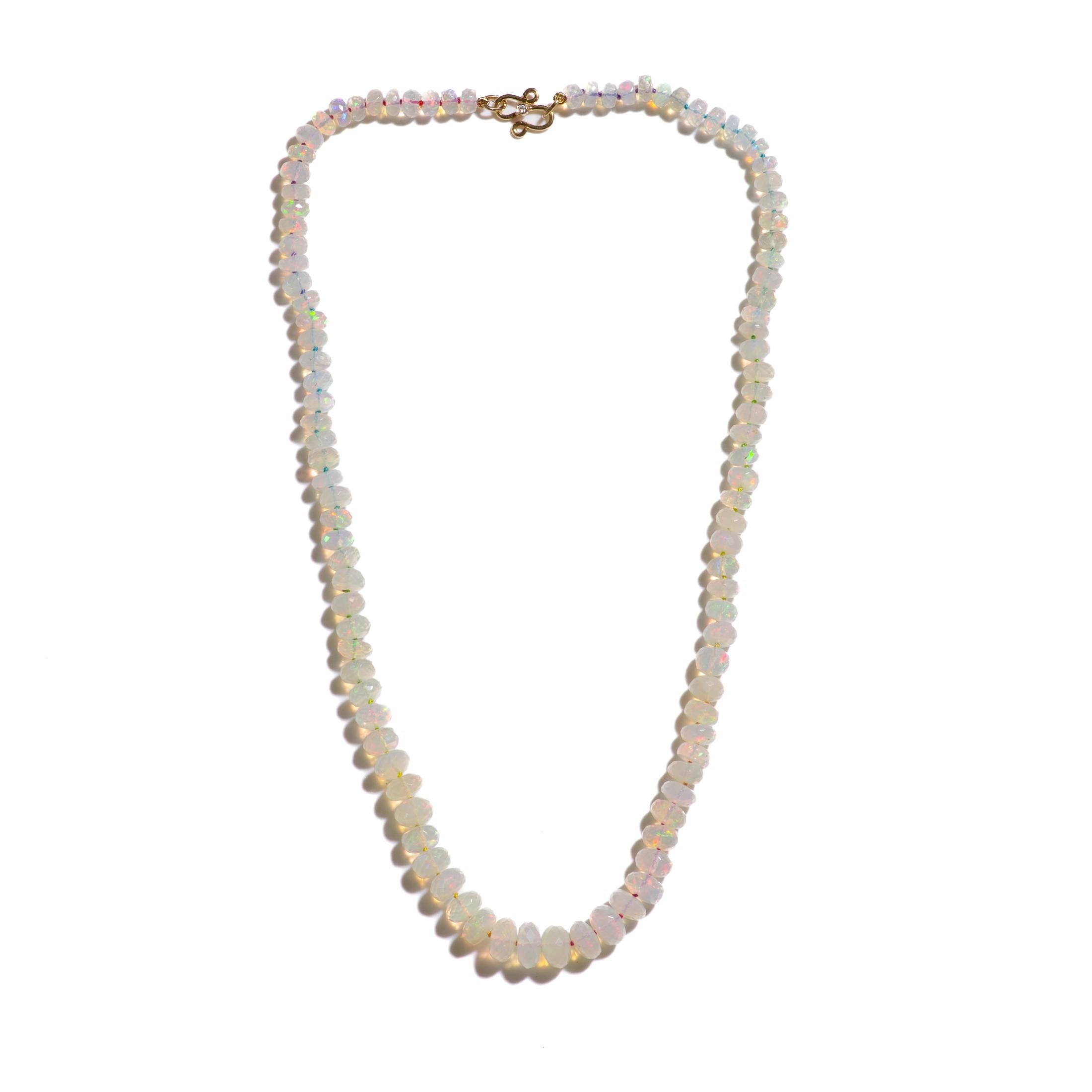 Large sparkling graduated Ethiopian opal necklace, methiciously hand knotted on silk finished with a 18K gold clasp. All stones are hand carved for an extra sparkling effect and contain a full spectrum of bright colors.

This beauty includes:
• The