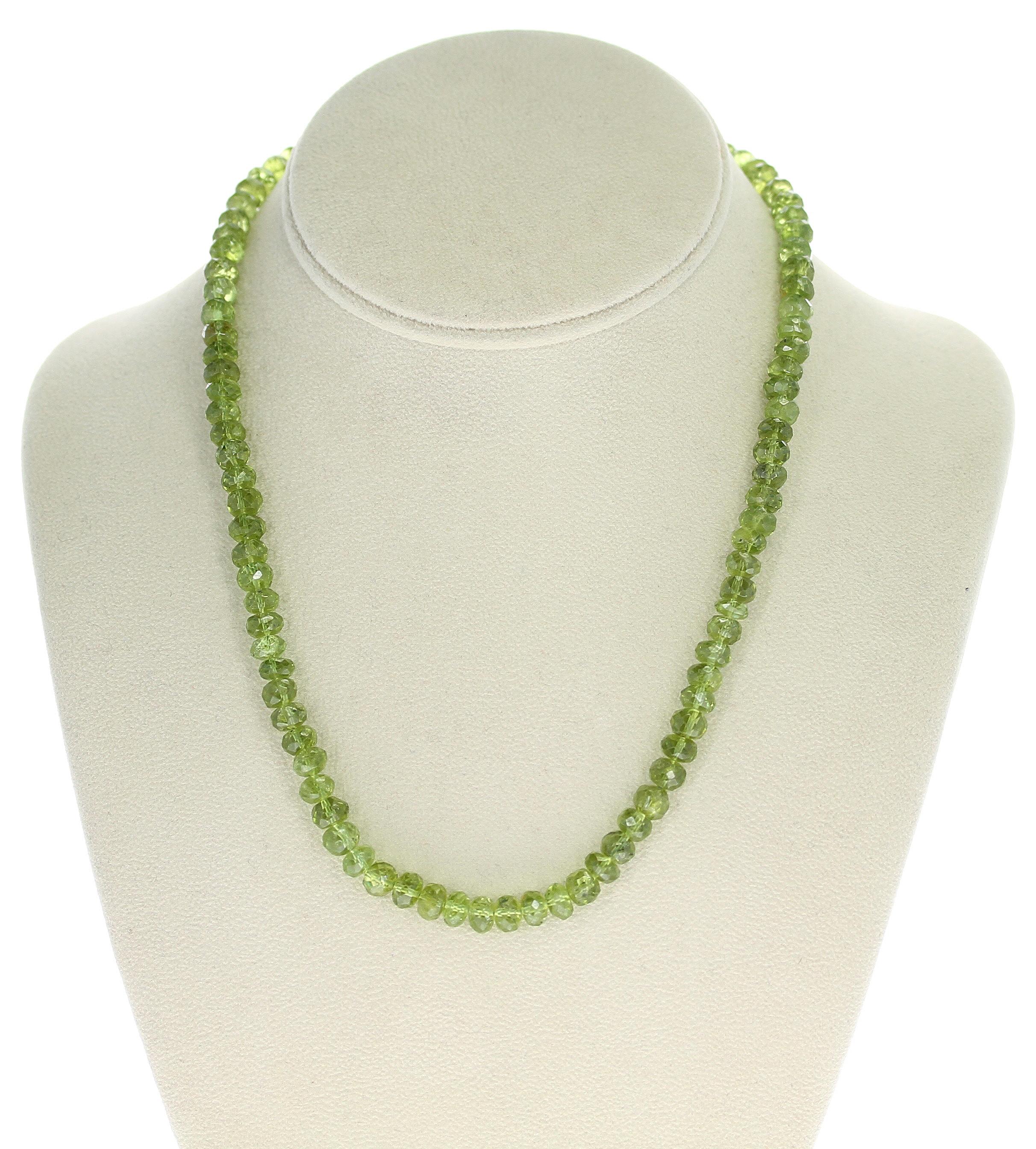 A Genuine Faceted 7MM Peridot Beads Necklace. The clasp is Sterling Silver. The necklace weighs 188 carats, the length is 18