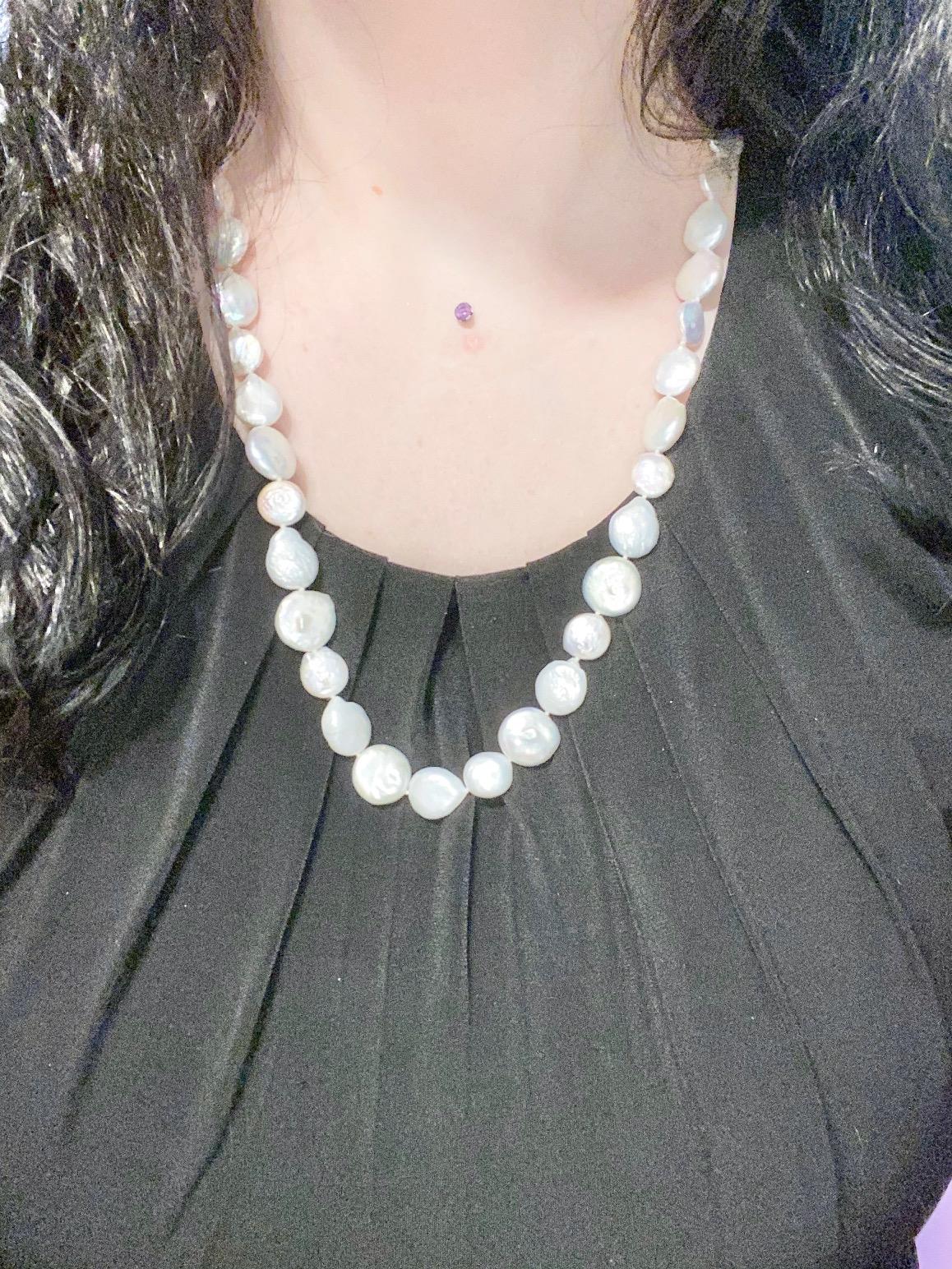 This genuine cultured pearl necklace will make you feel super confident!! It has coin pearls that have a high luster that brings rainbow hues out around them! The pearls on this necklace are an eye catching off white that sits beautifully with any