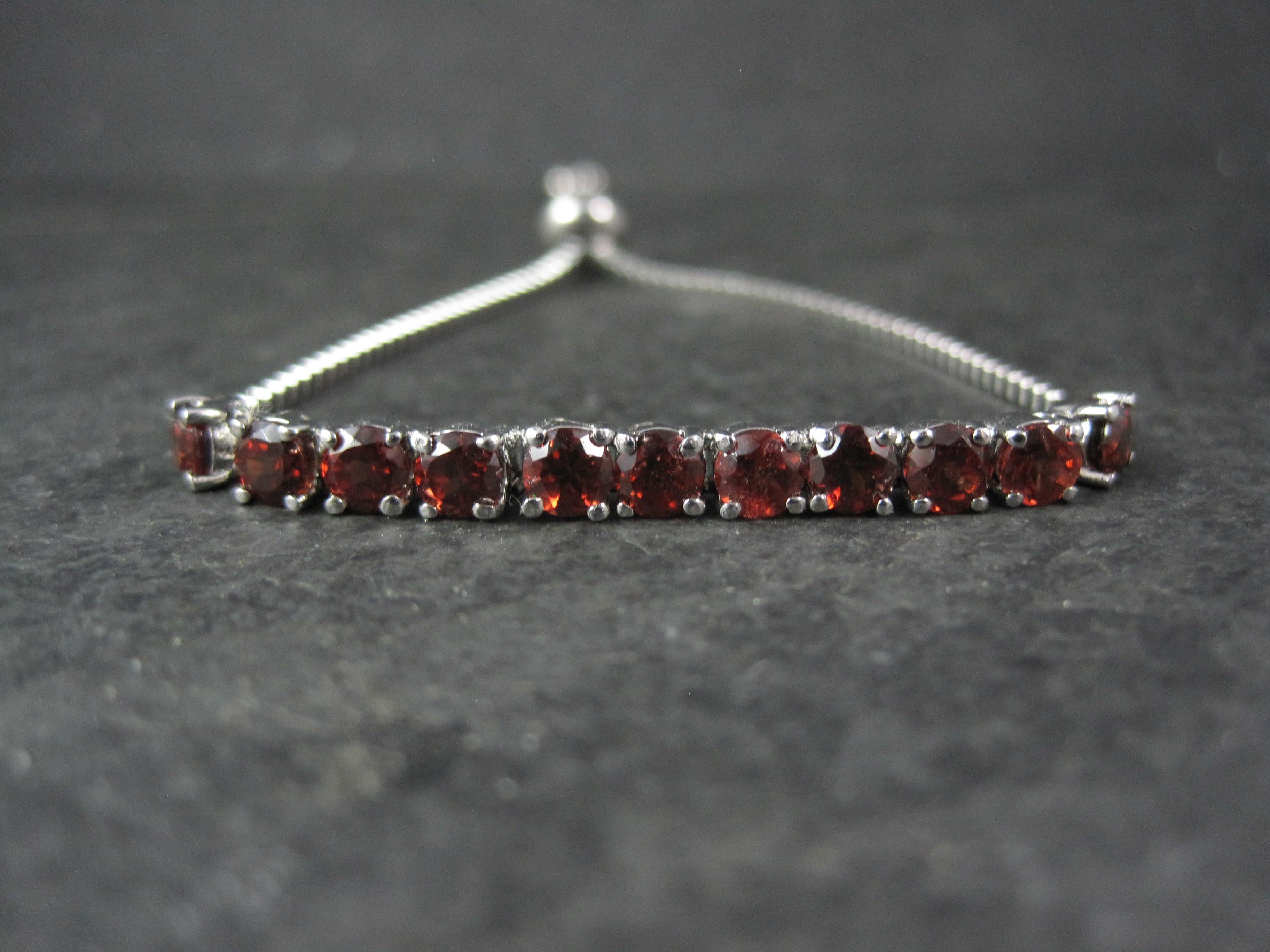 This gorgeous bolo bracelet is stainless steel.
The bracelet features 11 round cut 4mm garnets and is adjustable from 5 to 9 inches.
Marks: 316L,  S Steel
Condition: New/ Never worn