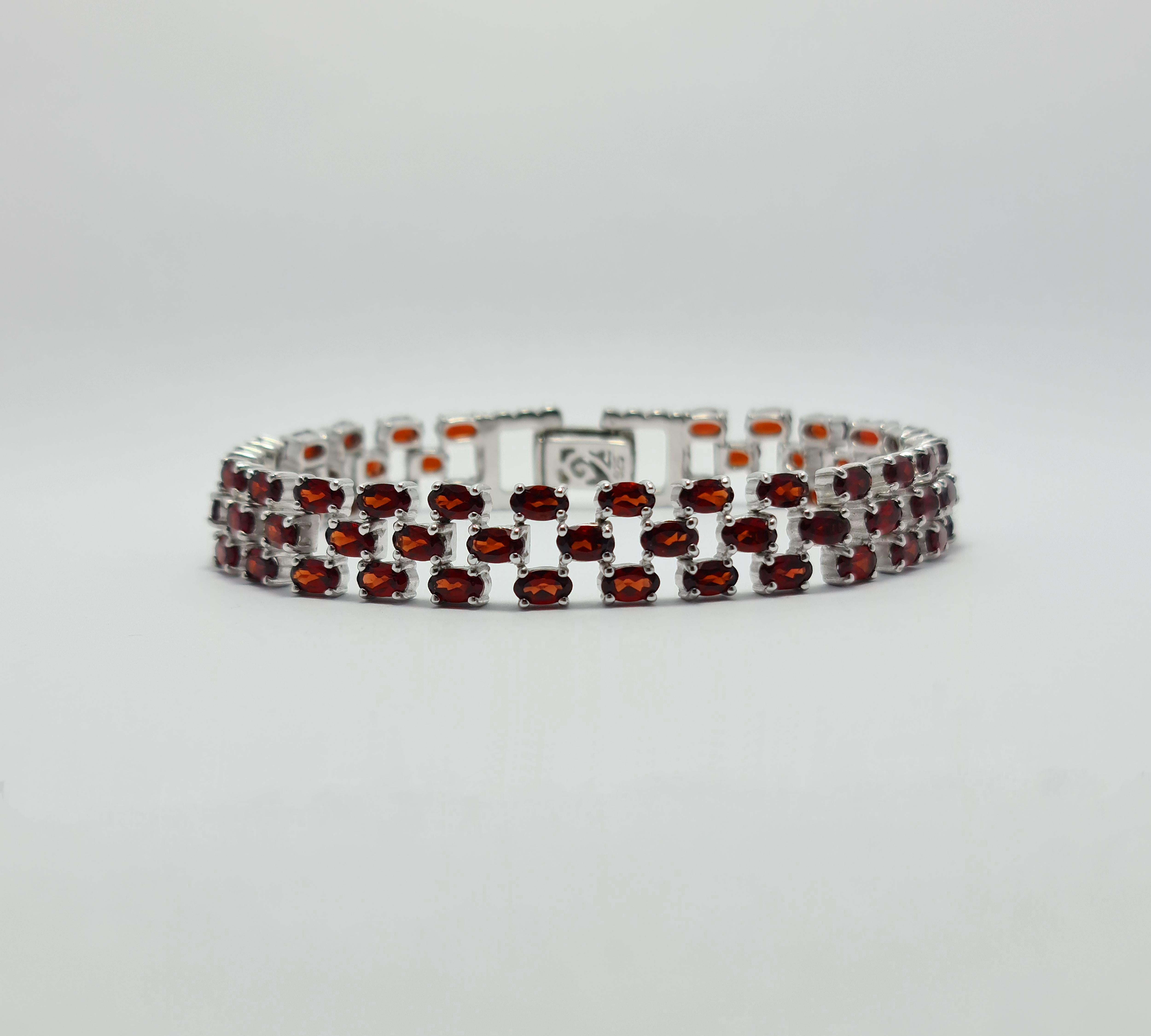 Natural Garnet Tennis Bracelet set in Pure 925 Sterling Silver with Rhodium Plating

Carat weight: 22 carats
Total bracelet weight: 24 grams
The Length of the Bracelet is 7.5 inches
