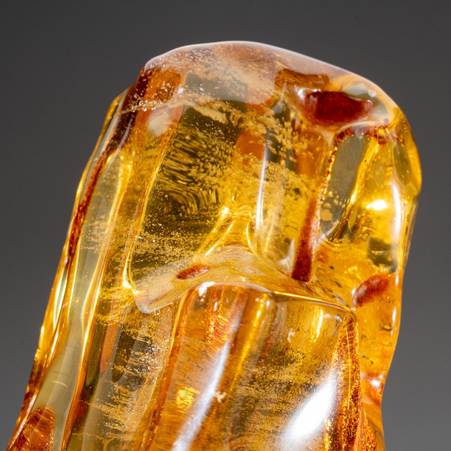 This transparent specimen of natural Colombian amber is polished to highlight its interior clarity and comprises some of the finest quality amber globally. Amber is prehistoric tree sap that has been fossilized. This solid specimen displays