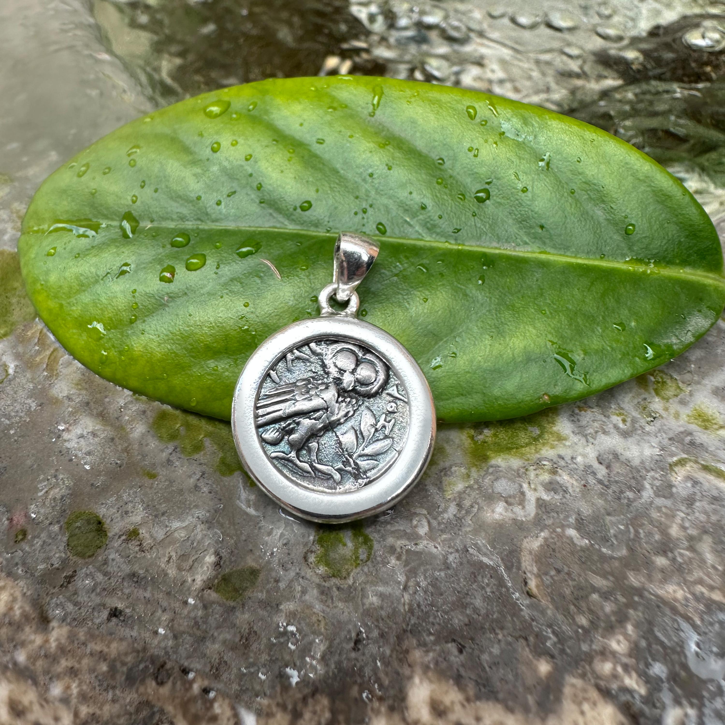 This sterling silver pendant is set with an authentic Greek silver coin from the 3rd Century BC depicting Goddess Athena's owl. On the reverse of the coin, Athena's head on the reverse side of the coin.

Nocturnal bird par excellence, in Greek