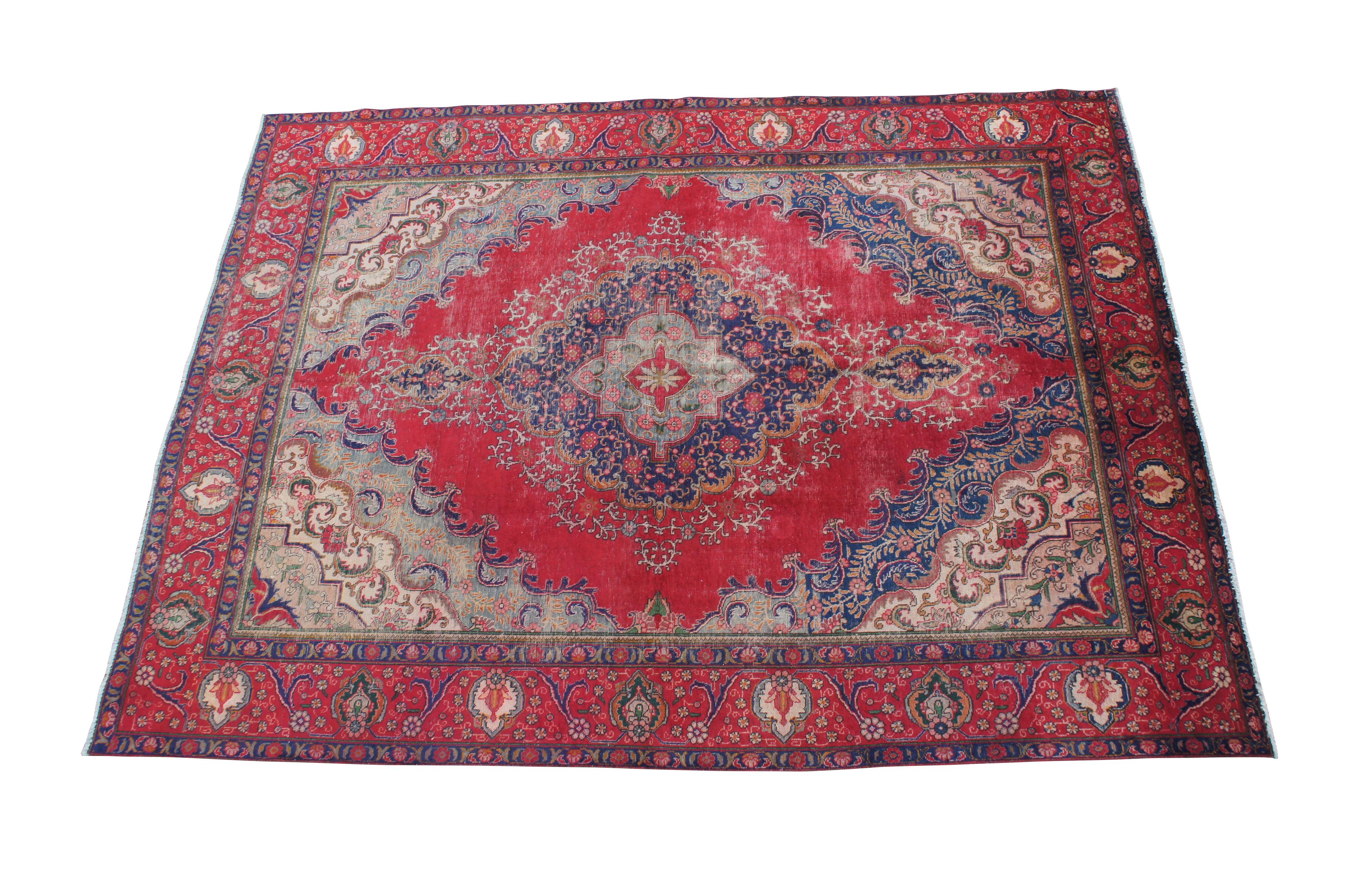 Very Fine wool oriental area rug from the second half of the 20th century.  Hand knotted from wool with exquisite layered medallion and foliate detail throughout. Includes shades of red, blue, green, pink, beige and orange.  196 kpsi

Persian Tabriz
