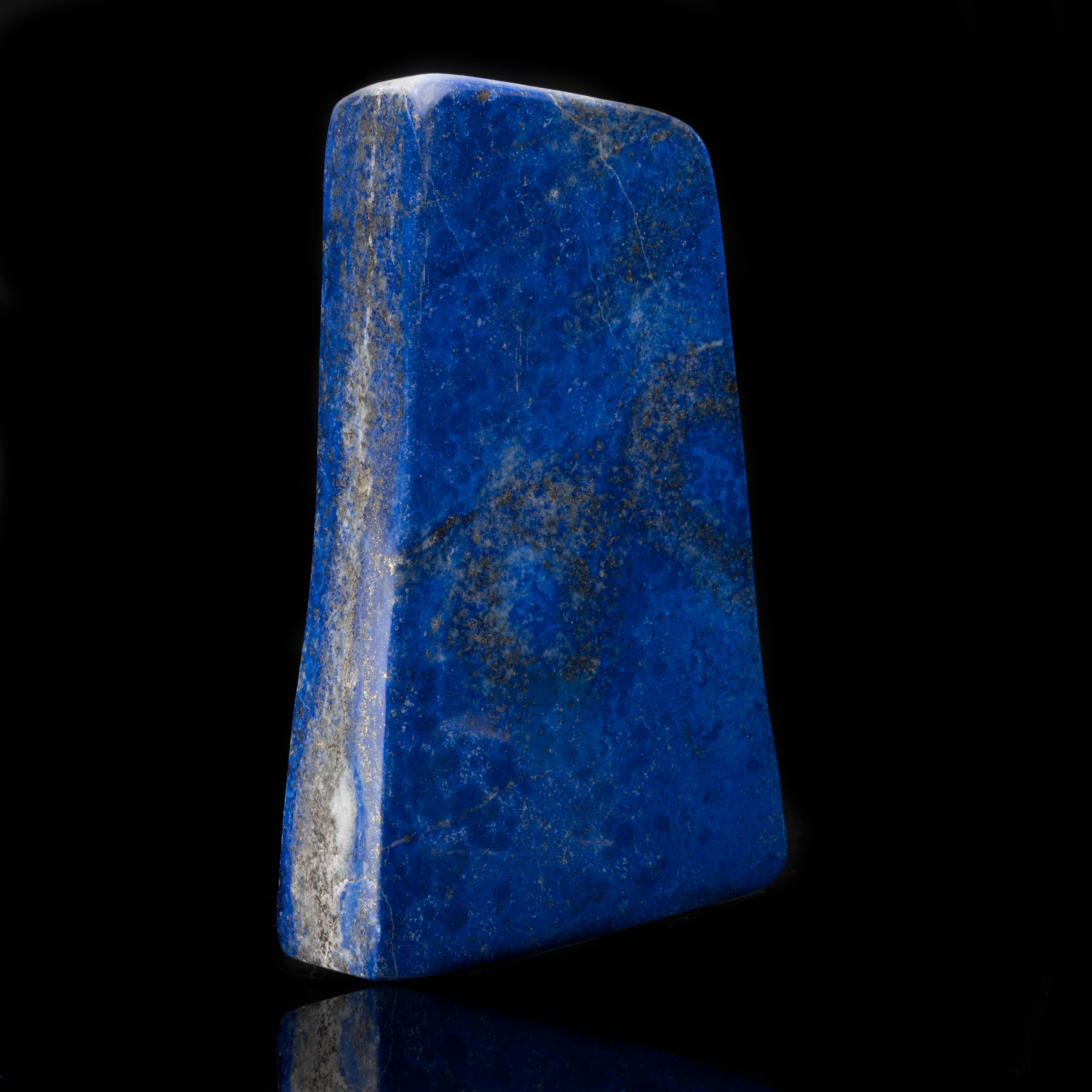 This beautiful cobalt blue freestanding lapis lazuli freeform has been hand-polished and features shimmering golden pyrite deposits and contrasting veins of white calcite running throughout. A handsome addition to any collection.