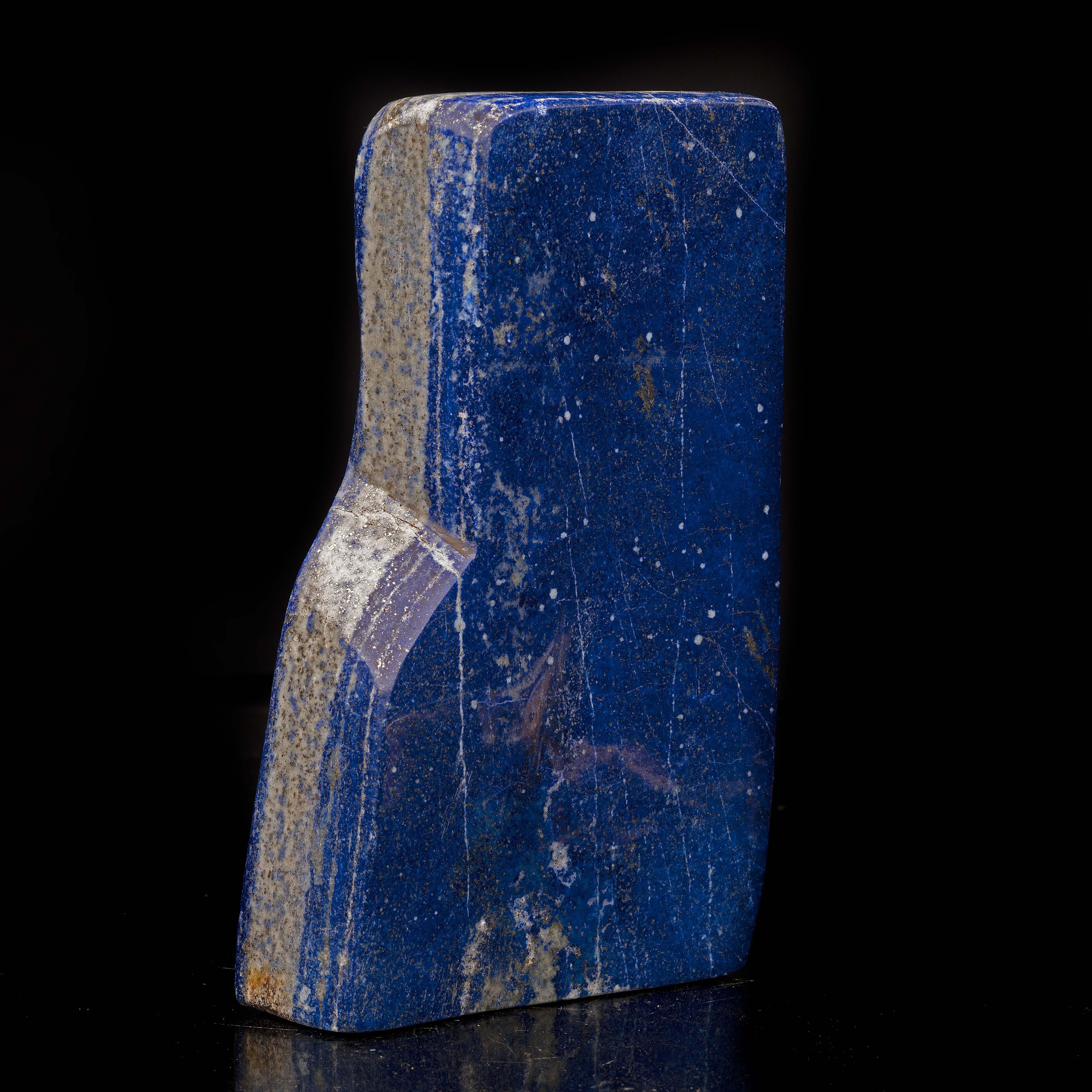 This gorgeous 3.33 lb hand-polished lapis lazuli freeform from Afghanistan features streaks of shimmering pyrite and white calcite deposits that appear like contrasting splatters on a vivid blue backdrop and create a uniquely painterly vibe. It