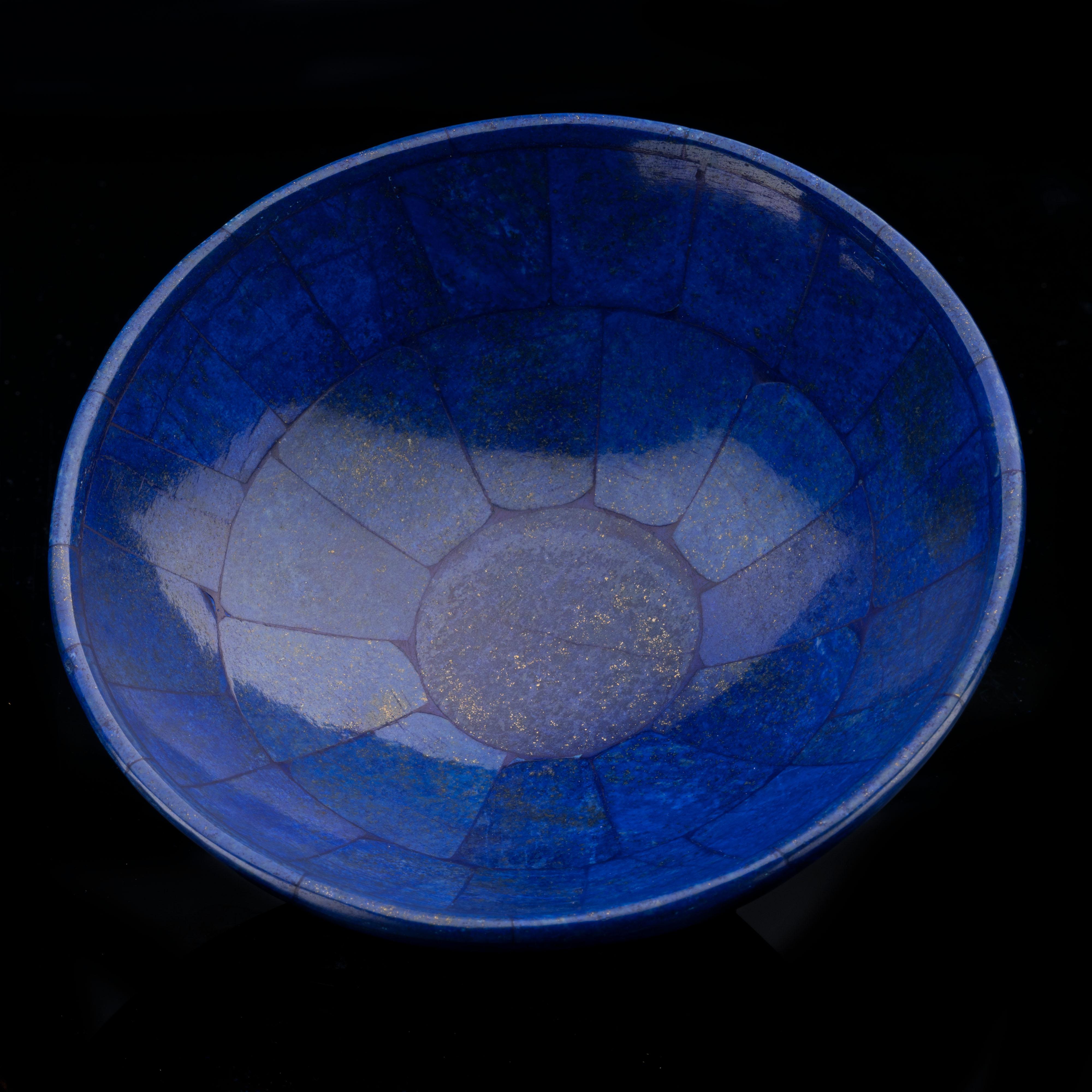 This standout home décor piece made from genuine high quality lapis lazuli has been hand-cut, hand-assembled, and hand-polished into a beautiful bowl. This handcrafted specimen displays a luxurious blue hue set off by the entrancing golden shimmer