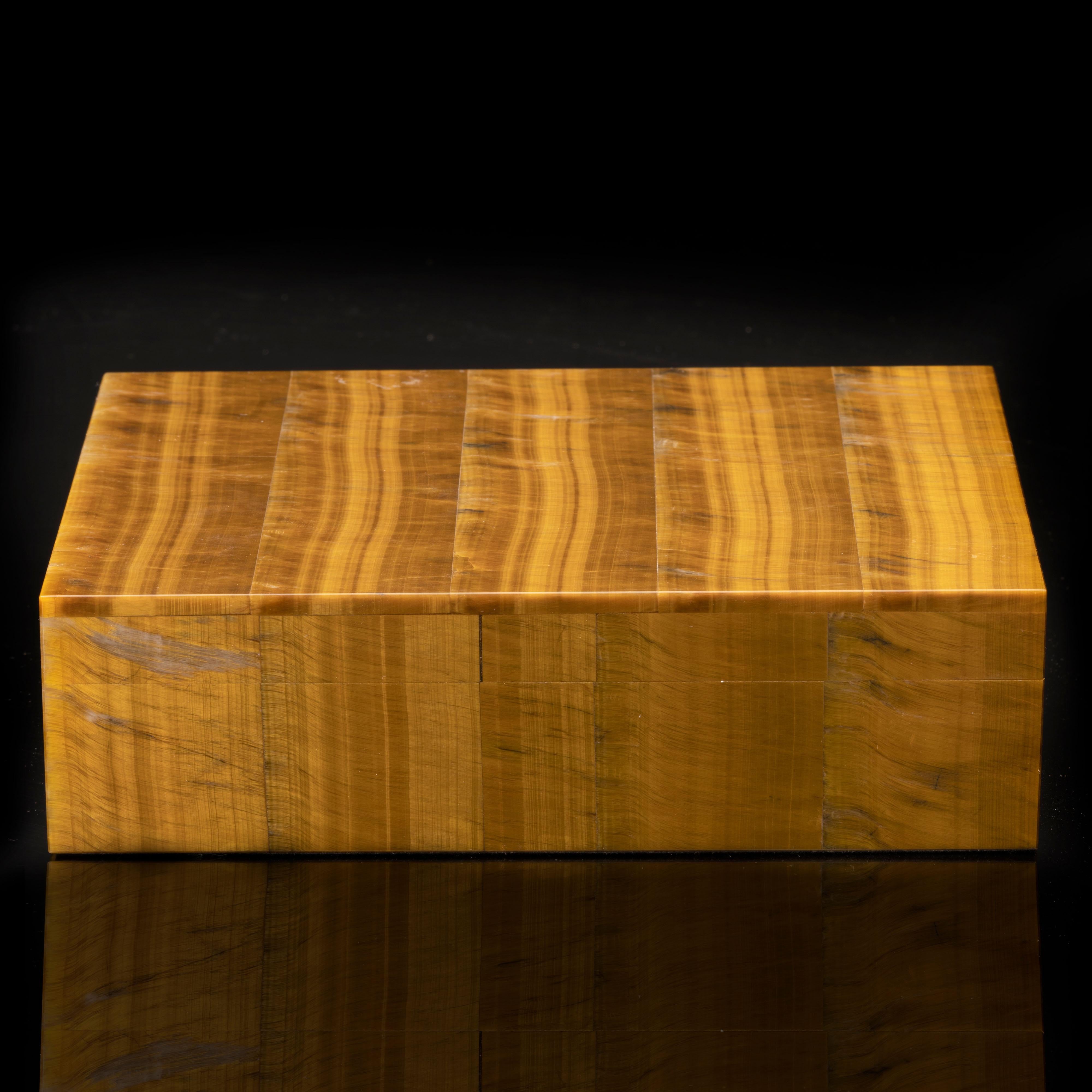 This seamlessly handcrafted box with hinged lid and brass hardware has been hand-carved and carefully hand-assembled in Italy out of the highest quality tiger's eye in gorgeous caramel and rich brown hues and with incredible chatoyance. Weighing