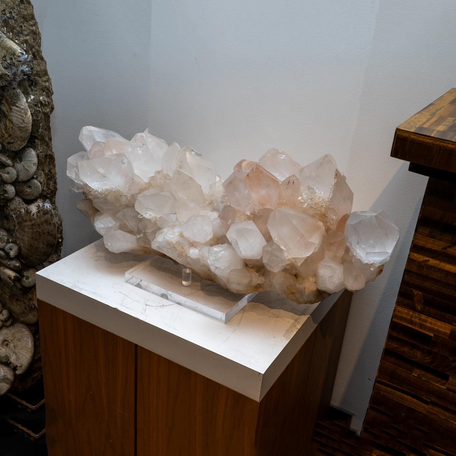 This Genuine Huge Clear Quartz Crystal Cluster Point from Brazil is a versatile addition to any home. With its complete termination and shiny, reflective surfaces, this crystal can serve as both an exquisite present and a striking decorative item.