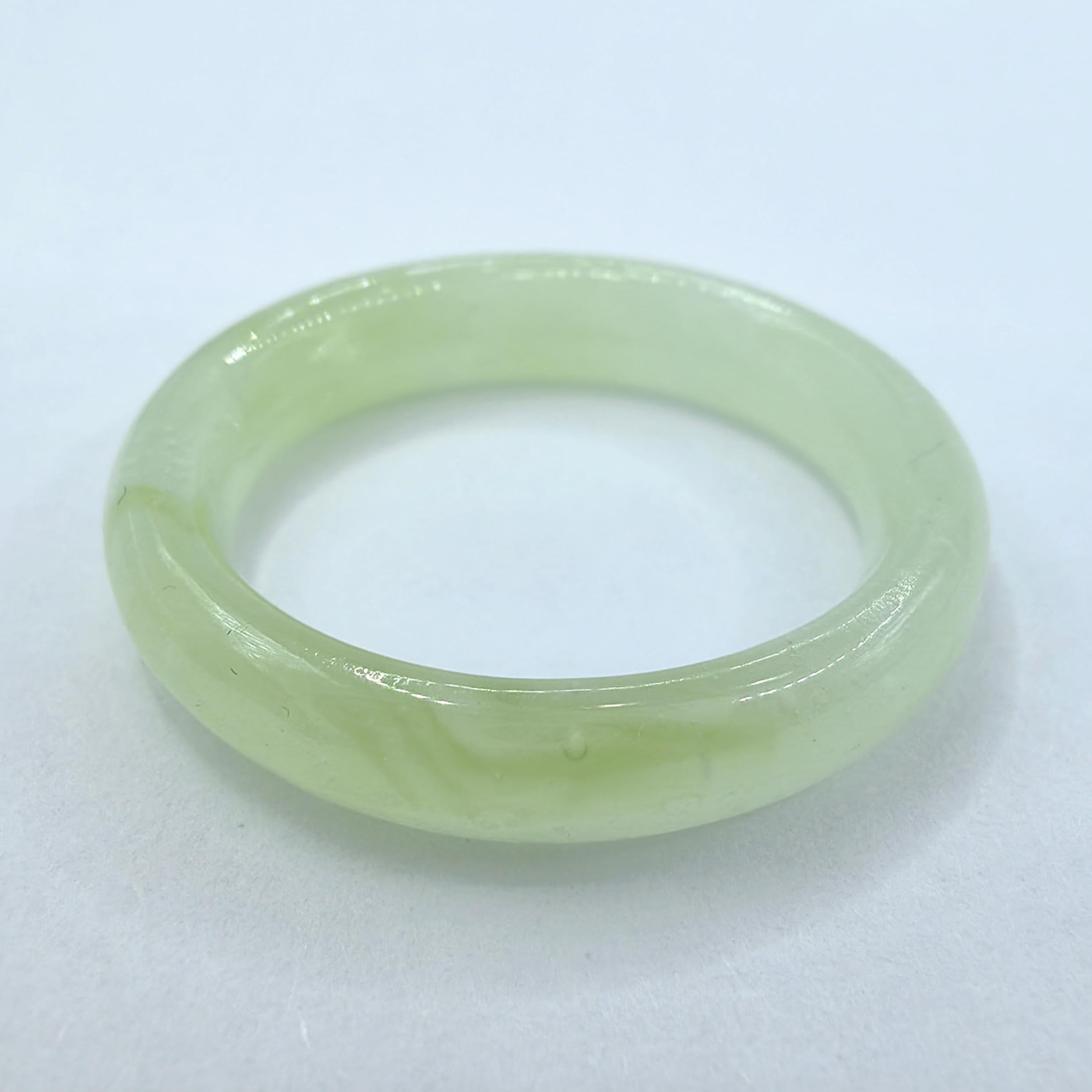 Indulge in the captivating allure of our Genuine Icy Light Apple Green Serpentine Jade Ring, meticulously crafted to showcase the exquisite beauty of Serpentine Jade. This natural gemstone, also known as New Jade or Xiuyan Jade, possesses a unique
