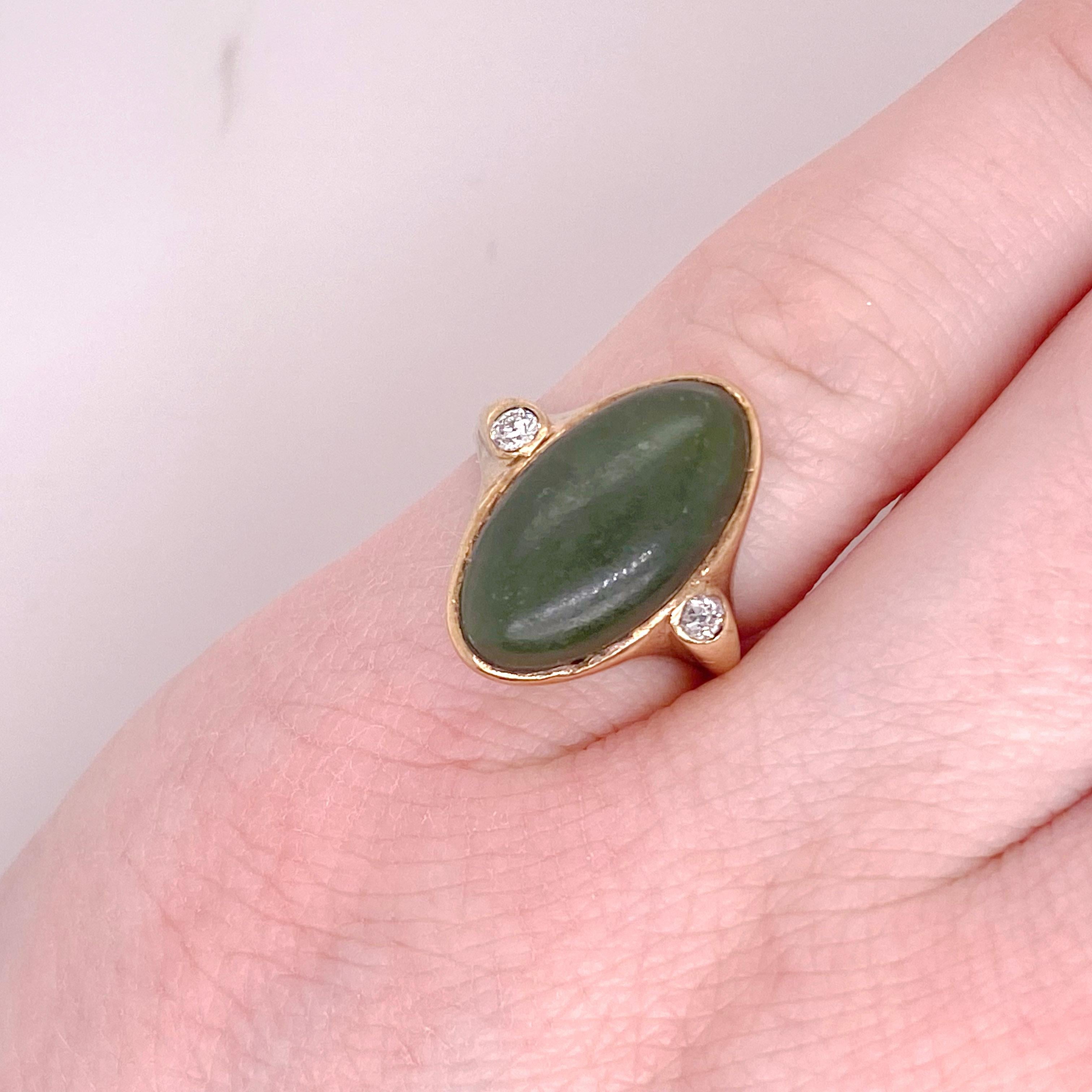 This genuine jadeite jade ring has an oval cut gemstone with a diamond on either side. The details of the beautiful ring are listed below:
14K Yellow Gold
Diamond Number: 2
Diamond Shape: Round
Diamond Total Weight: .12 Carat 
Diamond Quality: SI1