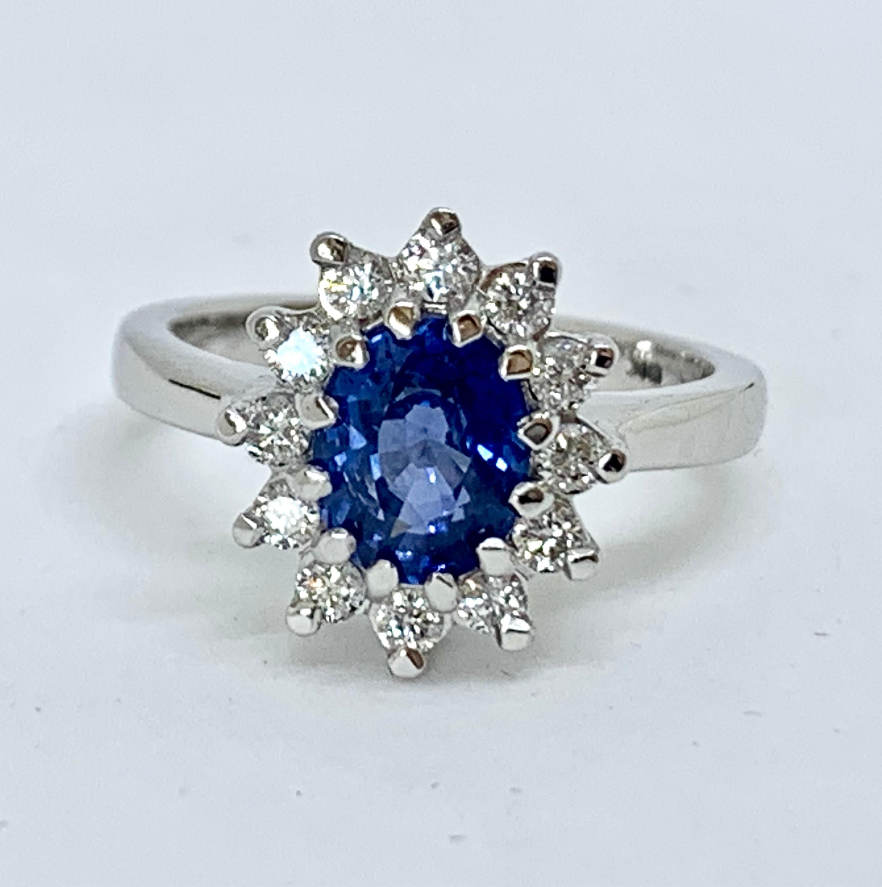 This Beautiful Ring Features a Natural Ceylon Sapphire.
Stunning in its simplicity, the ring features a 1.70ct Natural Sapphire with origin from Ceylon (now Sri Lanka).
It is surrounded by a halo of sparkling Diamonds  and the design gives a