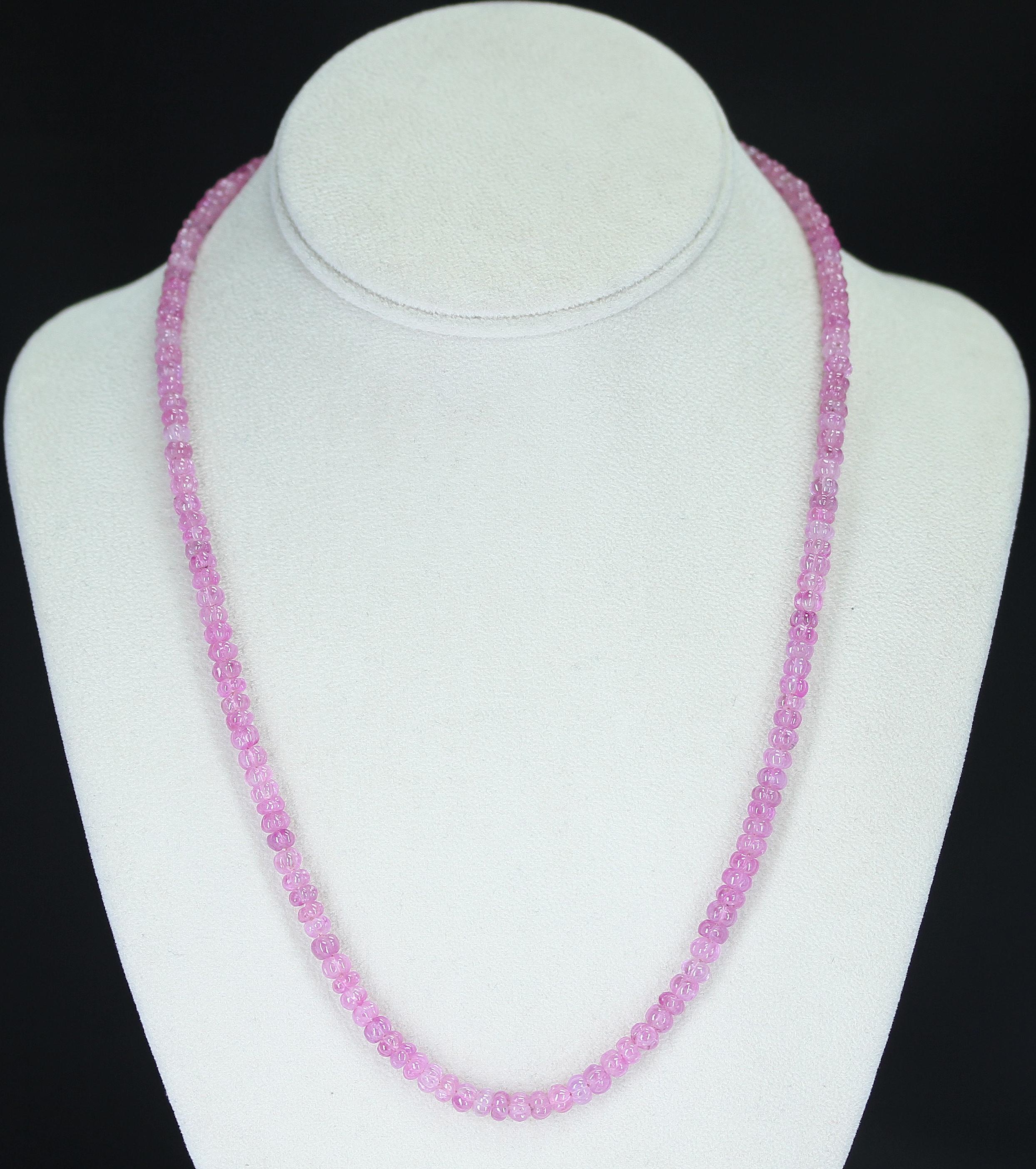 A Genuine & Natural Pink Sapphire Carved Beads Necklace with a 14K Clasp. The necklace weighs 145 carats, the length is 21 inches, and the beads range from 5MM to 5.50MM. 

We can also customize the necklace according to your preferences, as per the