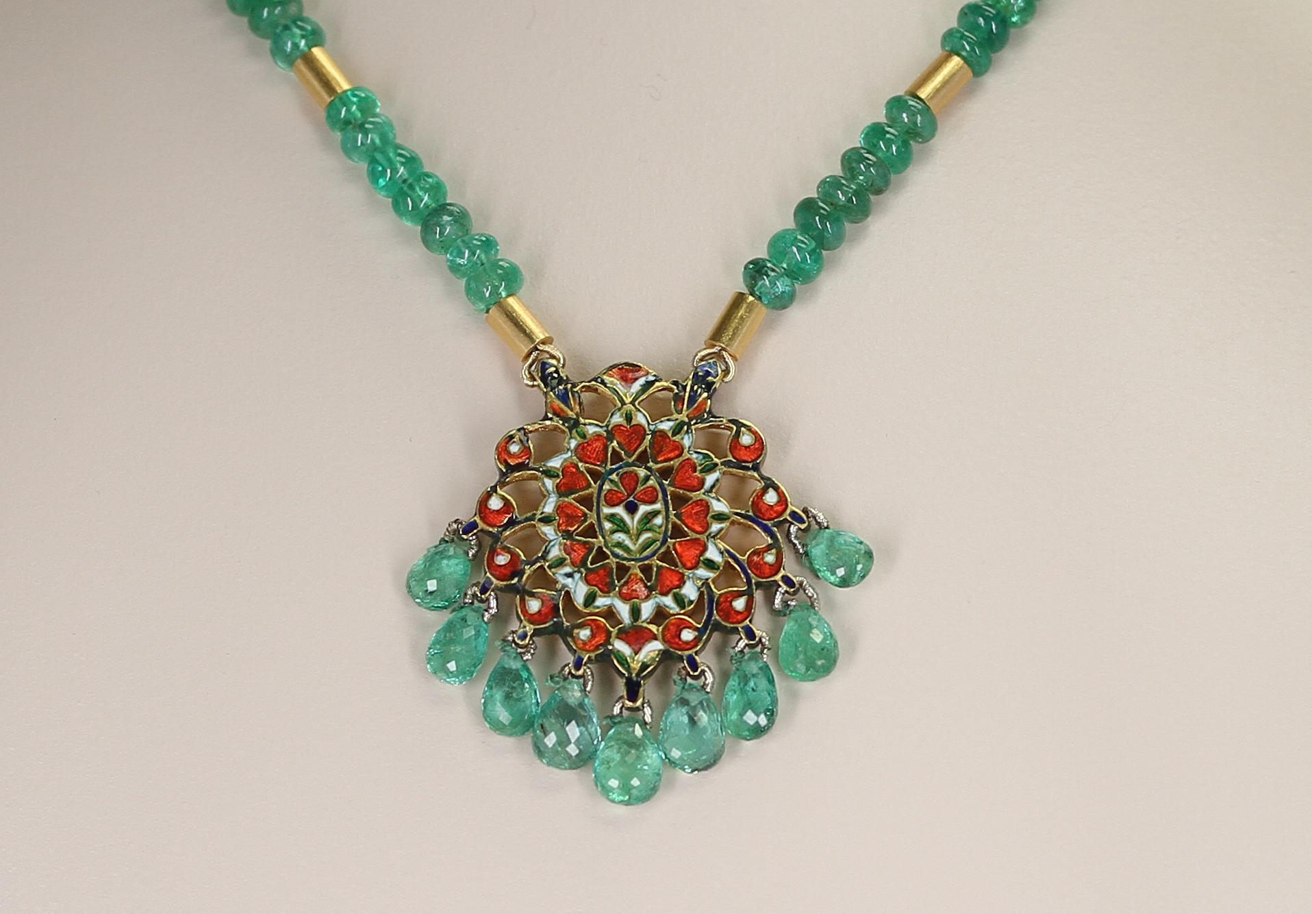 A Genuine & Natural Plain Emerald Beads Necklace with an Indian Kundan Enamel Pendant. The emerald beads are 5 to 6MM. The clasp is 14K Yellow Gold. Total Weight: 193 carats, the length is 18 Inches. The Gold beads are 18 Karat. In the enamel