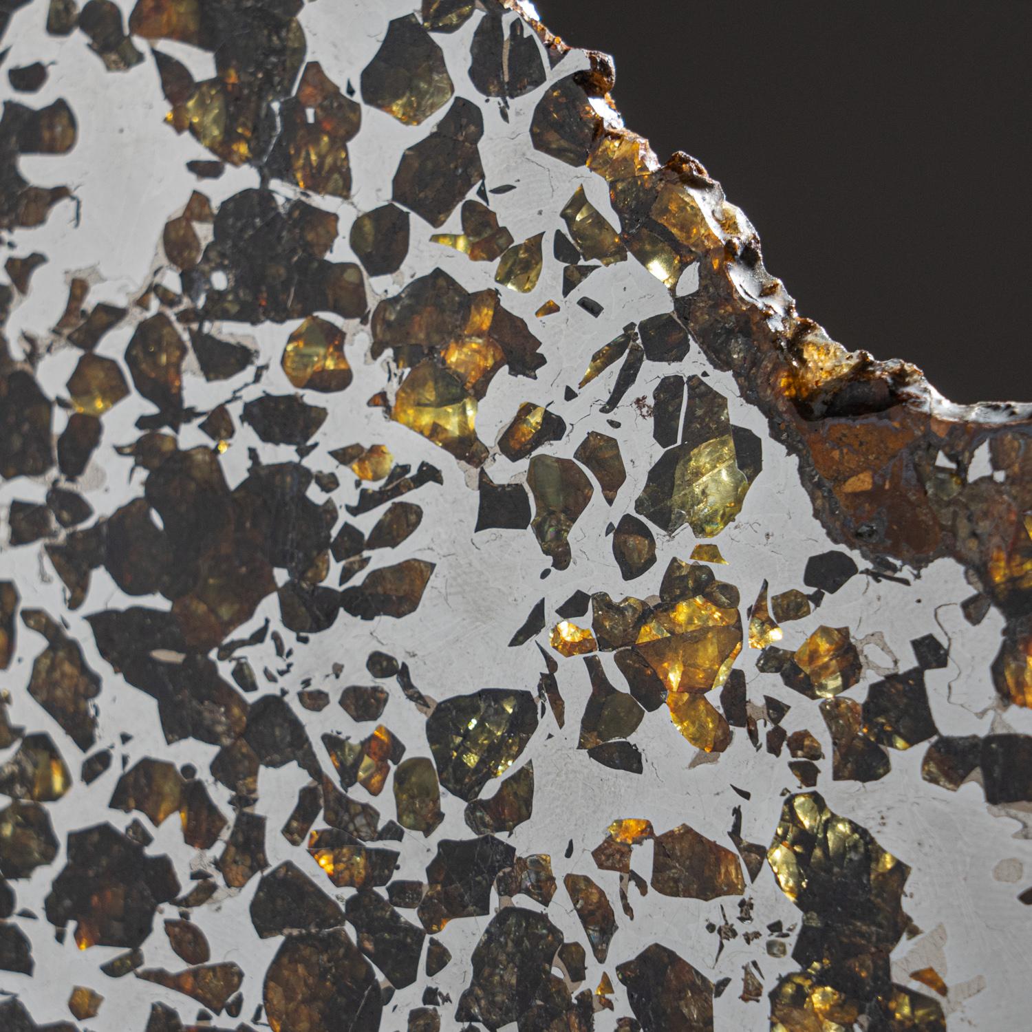 The pallasites are a class of stony–iron meteorite. It consists of centimeter-sized olivine crystals of peridot quality in an iron-nickel matrix. Coarser metal areas develop Widmanstätten patterns upon etching. Minor constituents are schreibersite,
