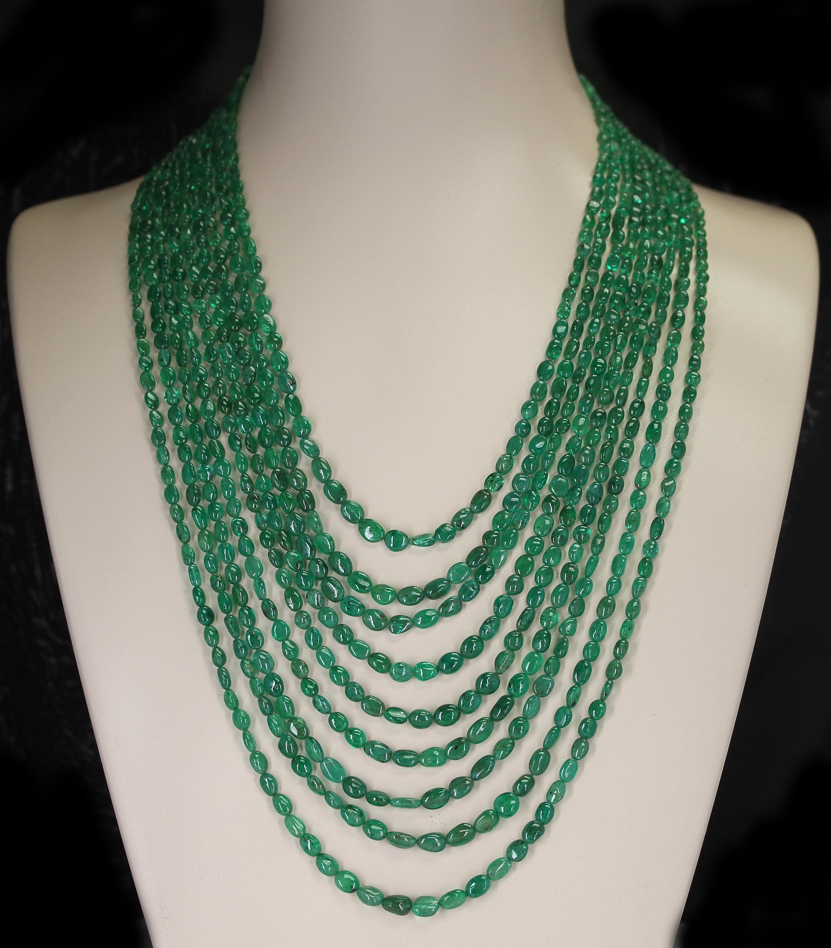 A Genuine & Natural Smooth Emerald Small Tumbled Beads Necklace with 9 Lines. The beads range from 5MM to 8 MM weighing 715 carats. The clasp is 14K Yellow Gold and the length ranges from 21.50