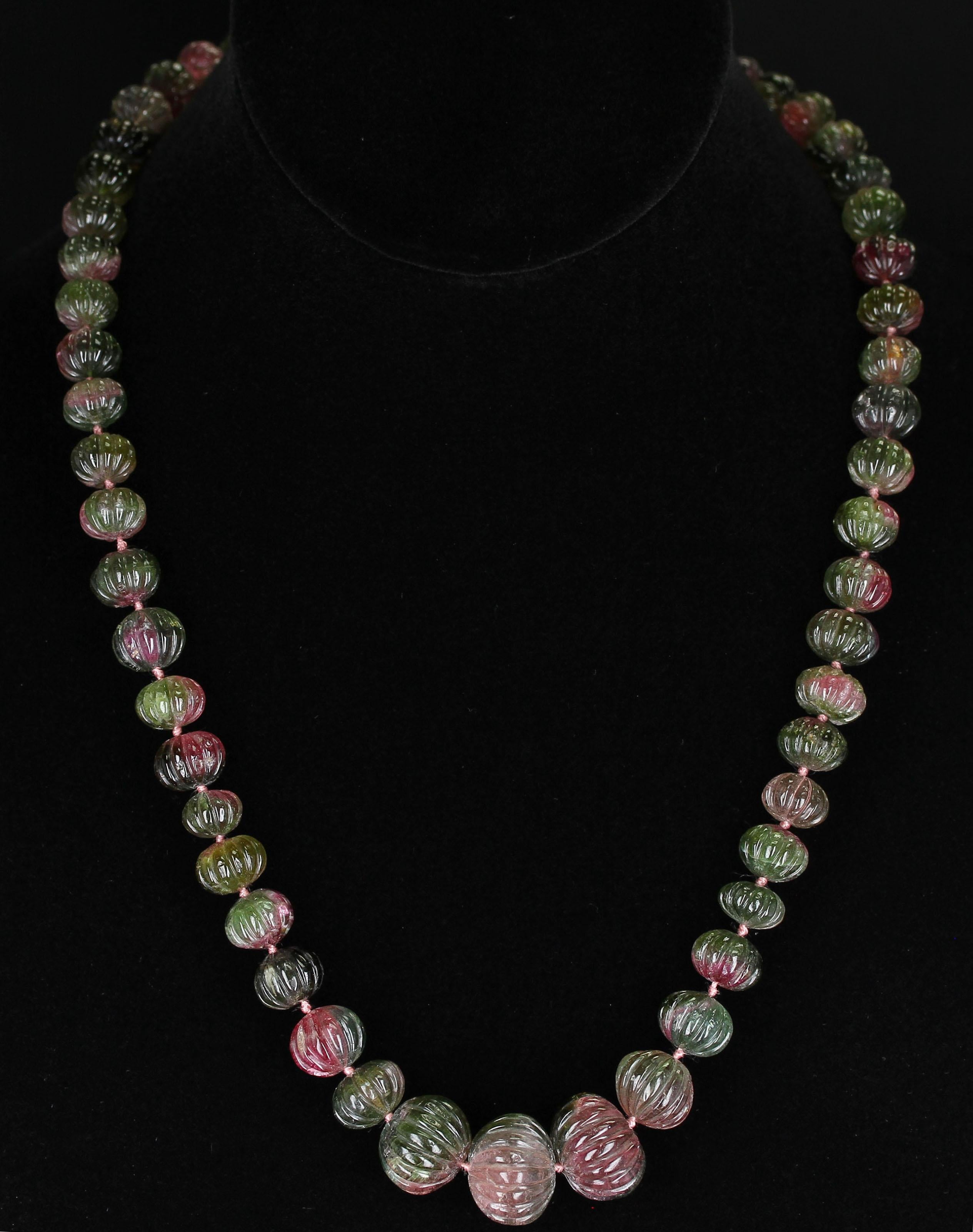 A Genuine & Natural Watermelon Tourmaline Carved Beads Necklace weighing 408 carats. The length is 20.5 Inches and the beads range from 9MM to 17MM. We can also customize the necklace according to your preferences, as per the number of strands, the