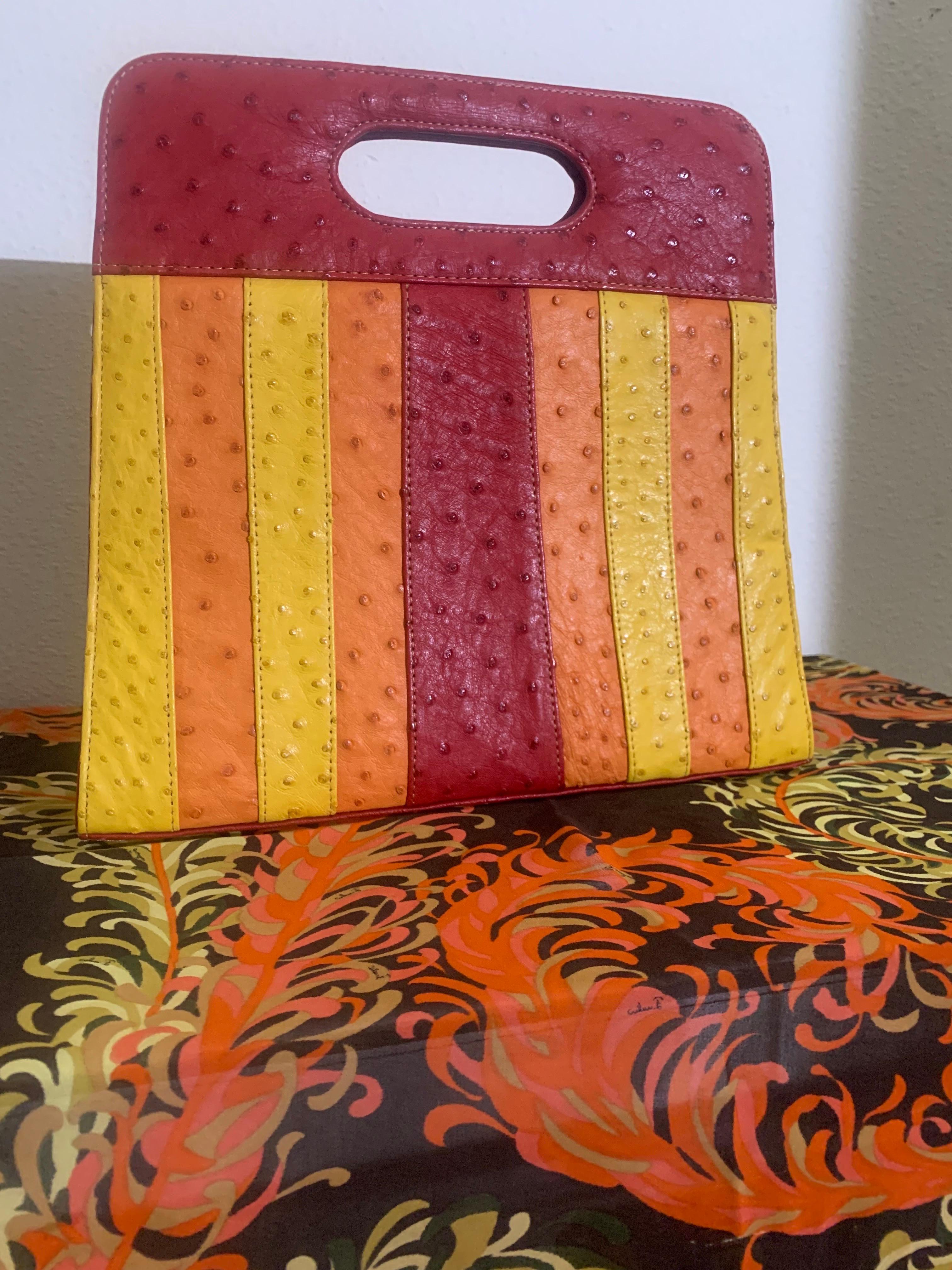 Genuine Ostrich Skin Color-Blocked Handbag in Burgundy, Orange and Yellow w Top Handle: Mod-inspired styling made in South Africa. Lined in pig suede with zippered pouch and pocket inside. Two magnectic clasps to close top. Pristine condition.