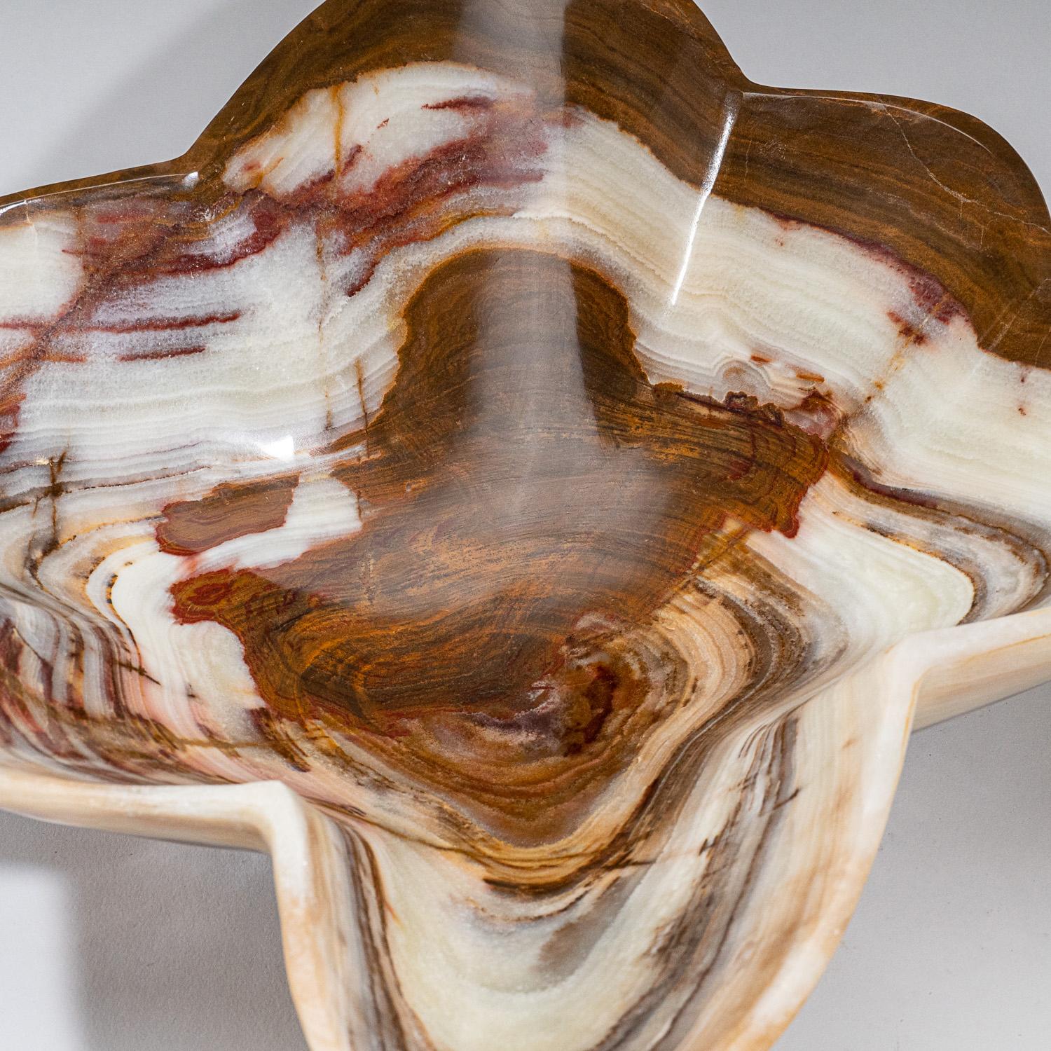 One-of-a-kind, solid mid sized free-form natural onyx decorative bowl carved out of a single chunk of banded natural onyx. This incredible piece is polished to a mirror finish. This unique piece blends natural onyx shades of white, honey and brown