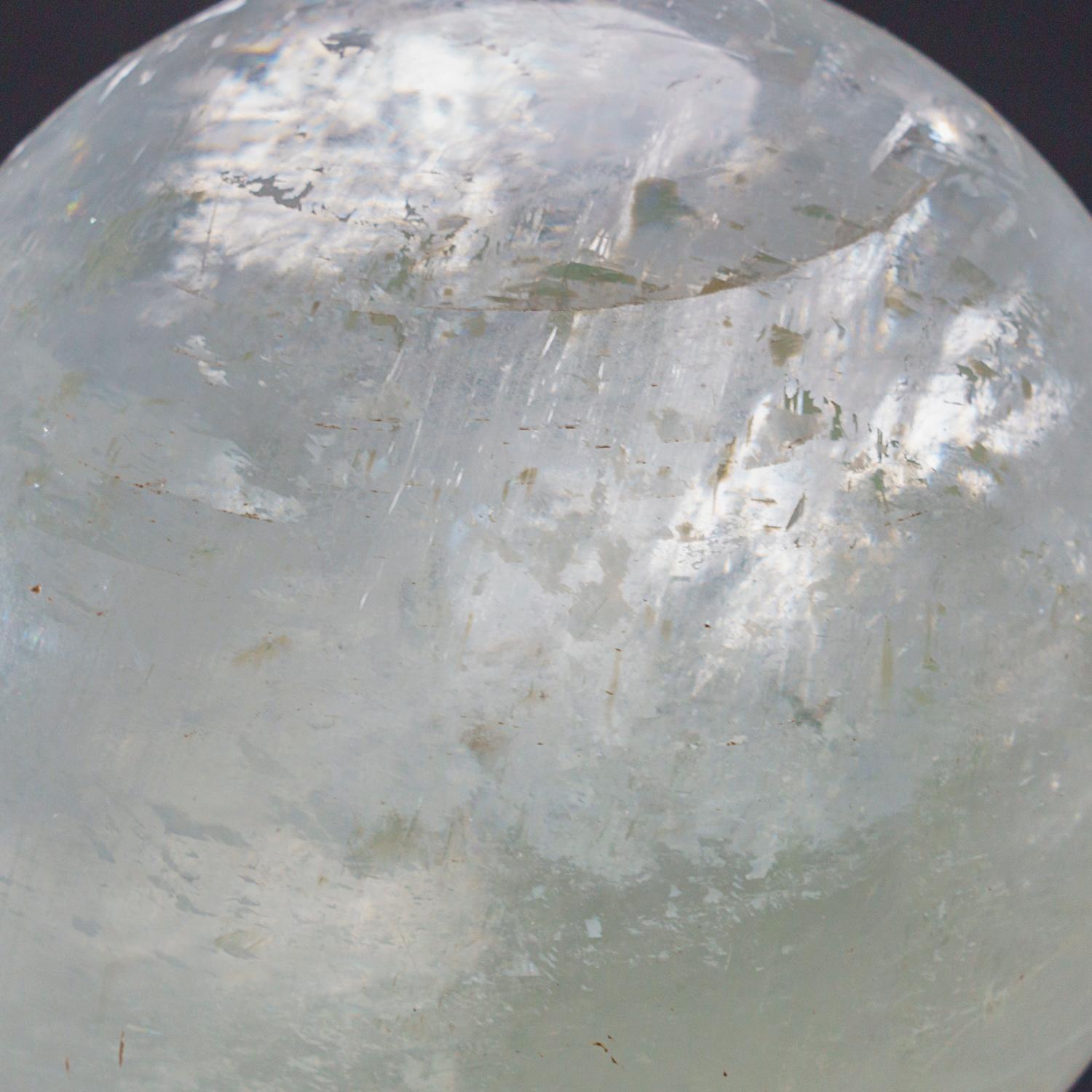 A beautiful Brazilian optical calcite sphere. This specimen has great transparency and is hand-polished to a beautiful smooth and highly reflective finish. 

Optical Calcite is a calcium carbonate mineral, being a colourless and transparent form of