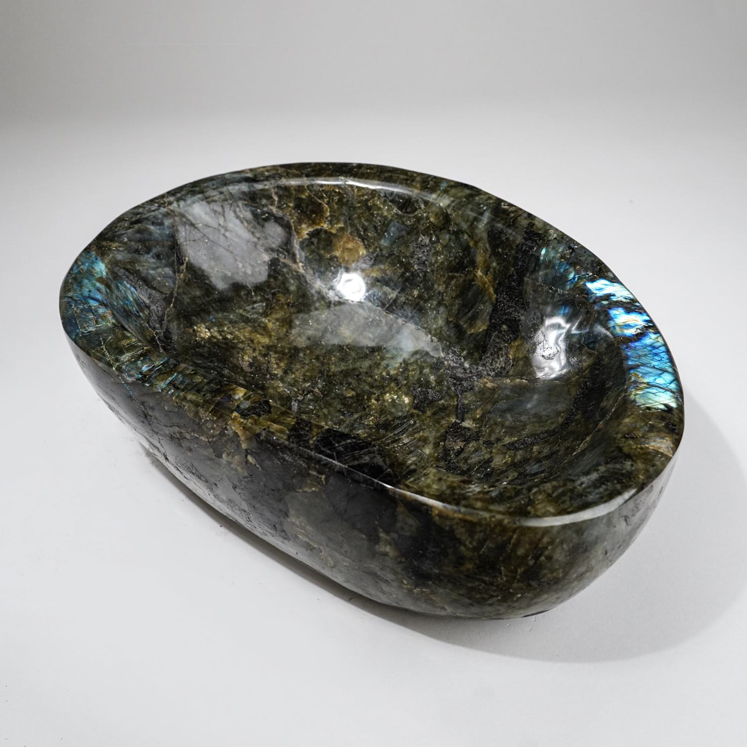 Beautiful hand polished labradorite decorative large bowl from Madagascar. This bowl has a beautiful, iridescent play of colors - blue and yellow which is caused by internal fractures in the mineral that reflect light back and forth, dispersing it