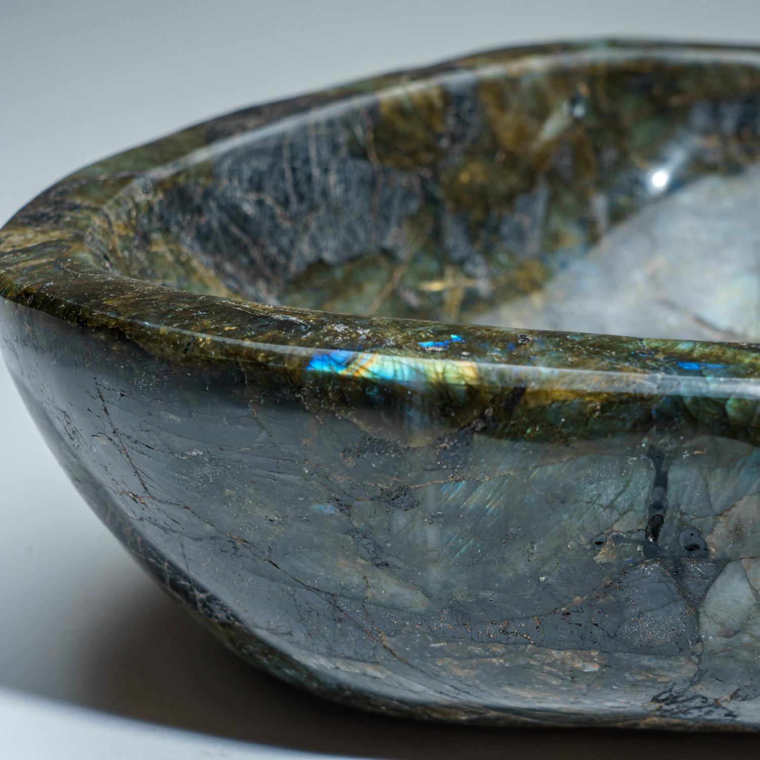 Beautiful hand polished Labradorite Bowl from Madagascar. This bowl has a beautiful, iridescent play of colors - blue and yellow which is caused by internal fractures in the mineral that reflect light back and forth, dispersing it into different