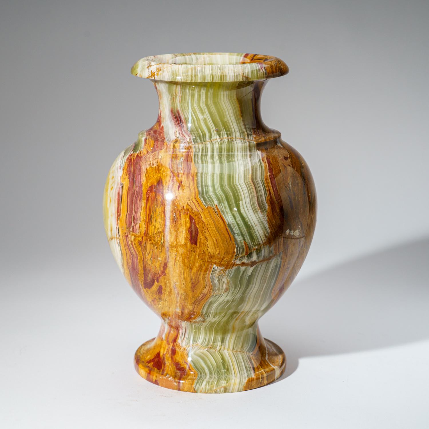 This polished onyx flower vase from Mexico adds a touch of timeless elegance to any space. Handcrafted from a single block of natural onyx, its distinctive translucent tones and grounding properties make it a unique and captivating piece.Its